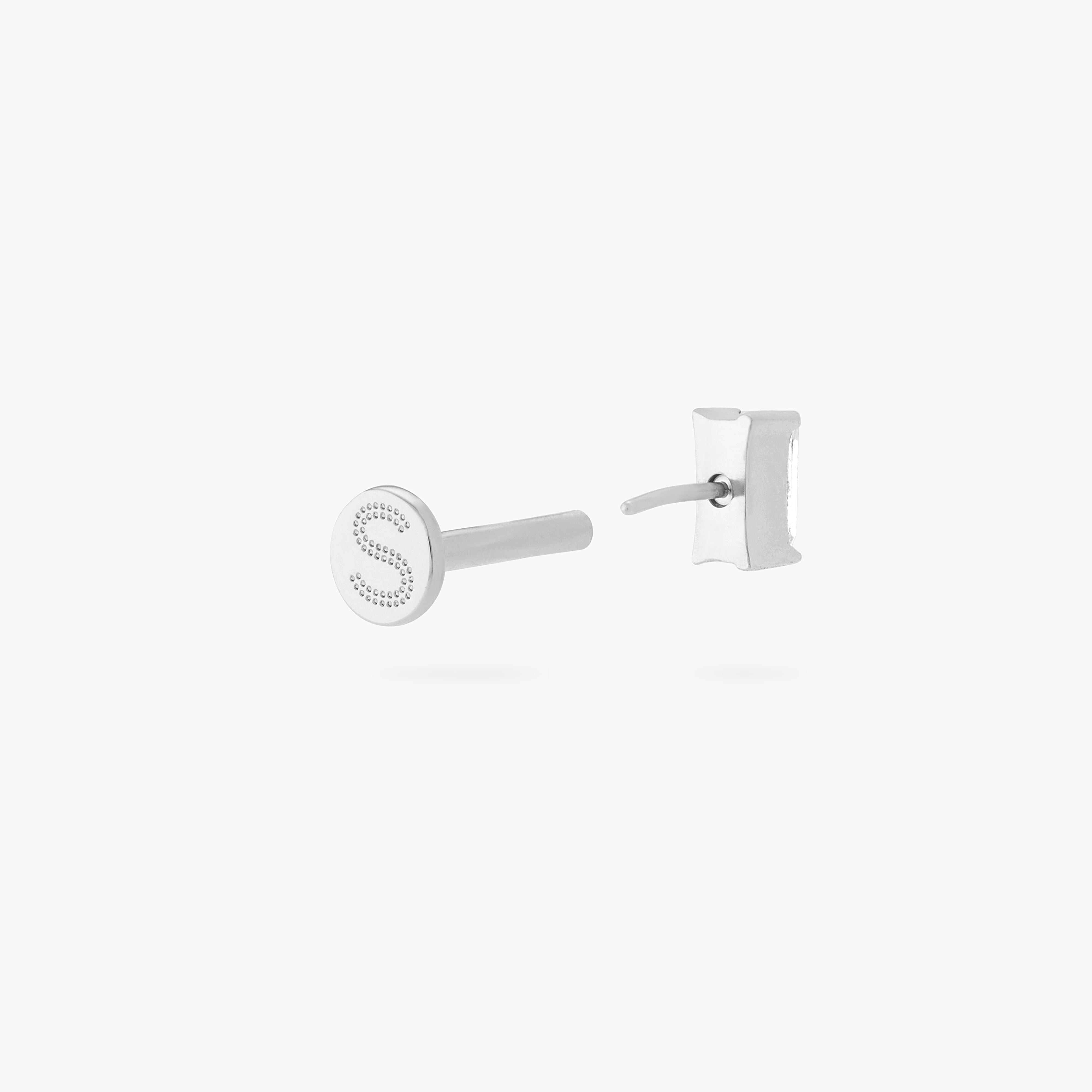 This is an image of a silver/clear baguette shaped CZ flatback stud, with a silver labret with a circle disc with an "S" logo engraved on it. color:null|silver/clear