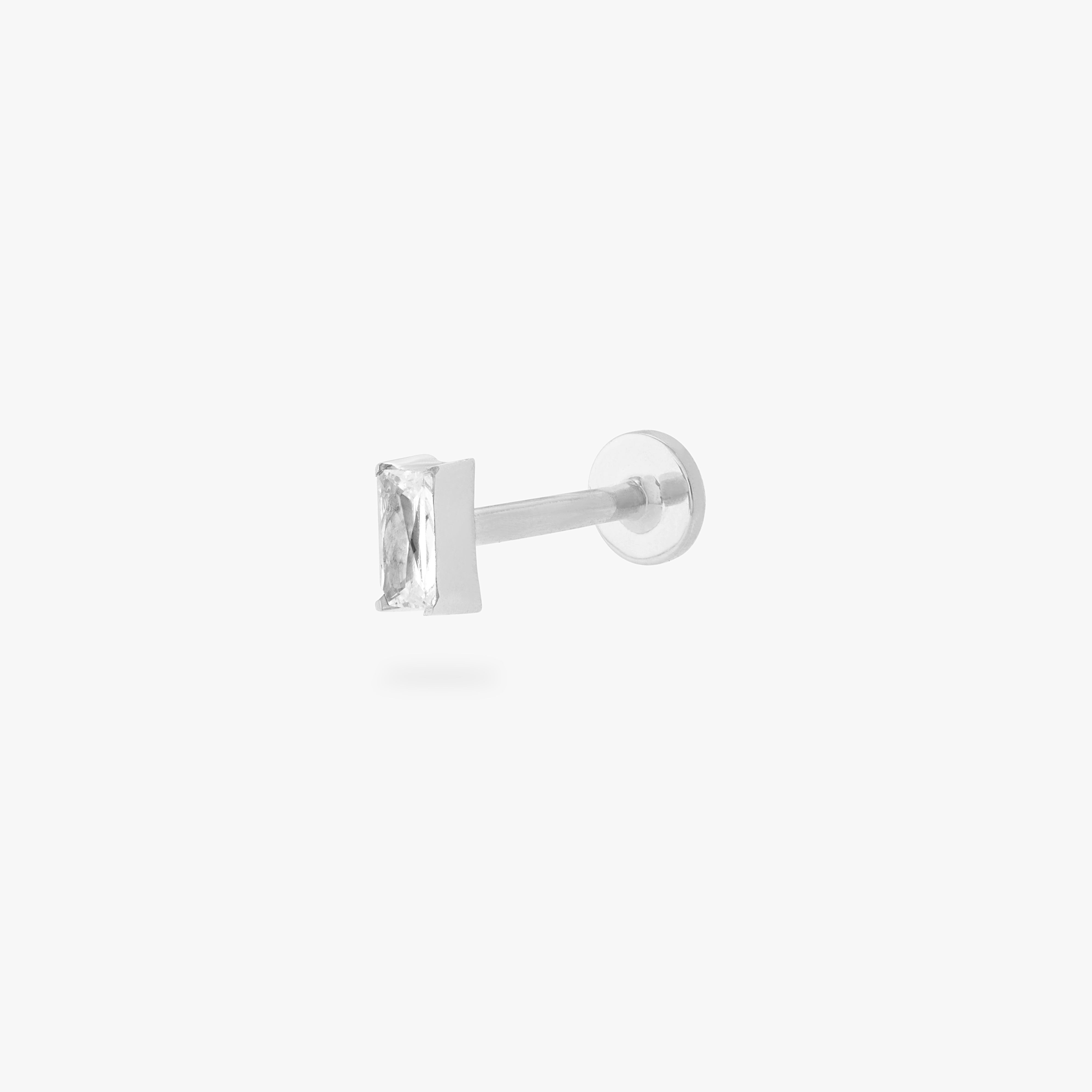 This is an image of a silver/clear baguette shaped CZ flatback stud, with a silver labret with a circle disc with an "S" logo engraved on it. color:null|silver/clear