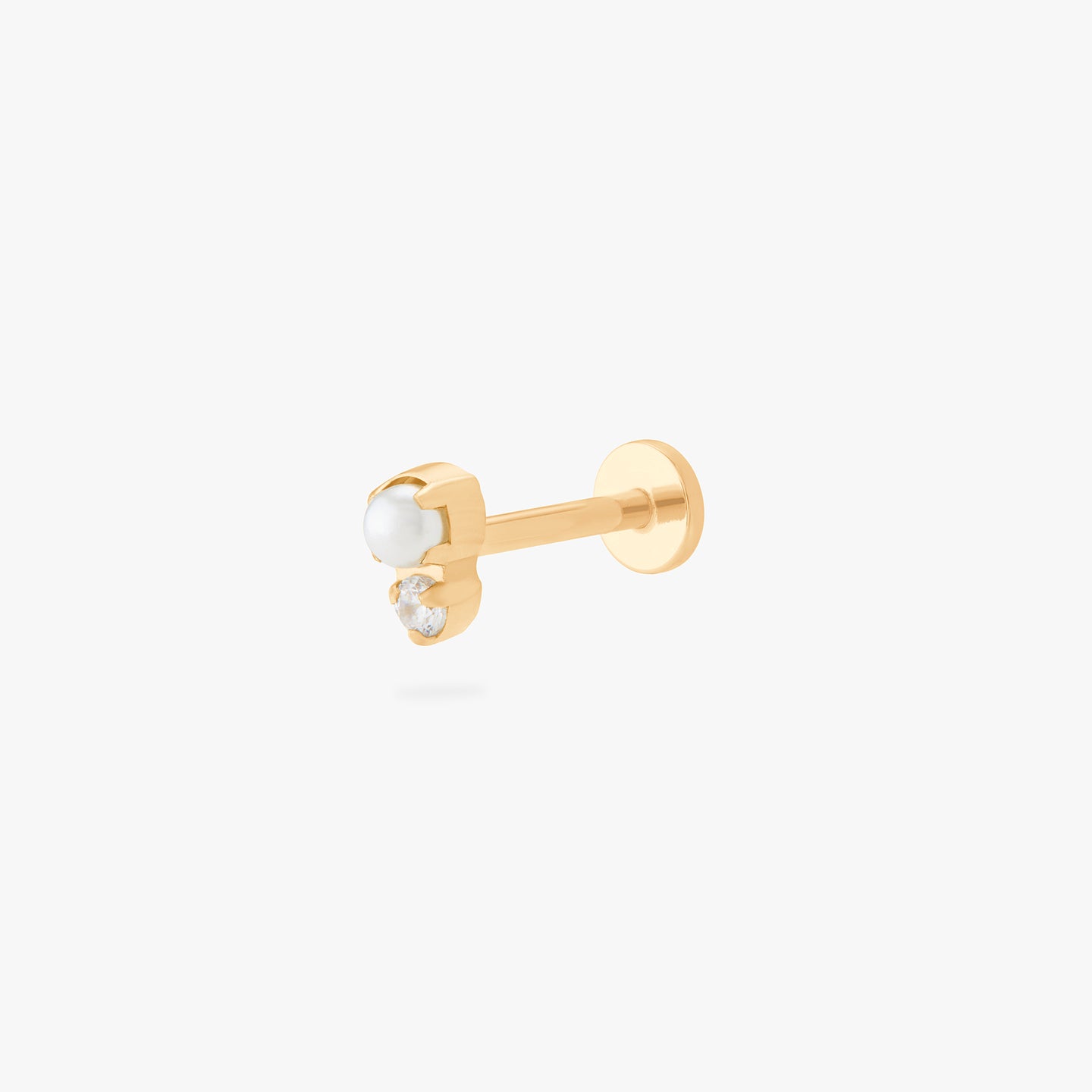 This is an image of a flatback top which has a pearl stacked over gold/clear CZ and then a gold labret that has a circle disc with the 