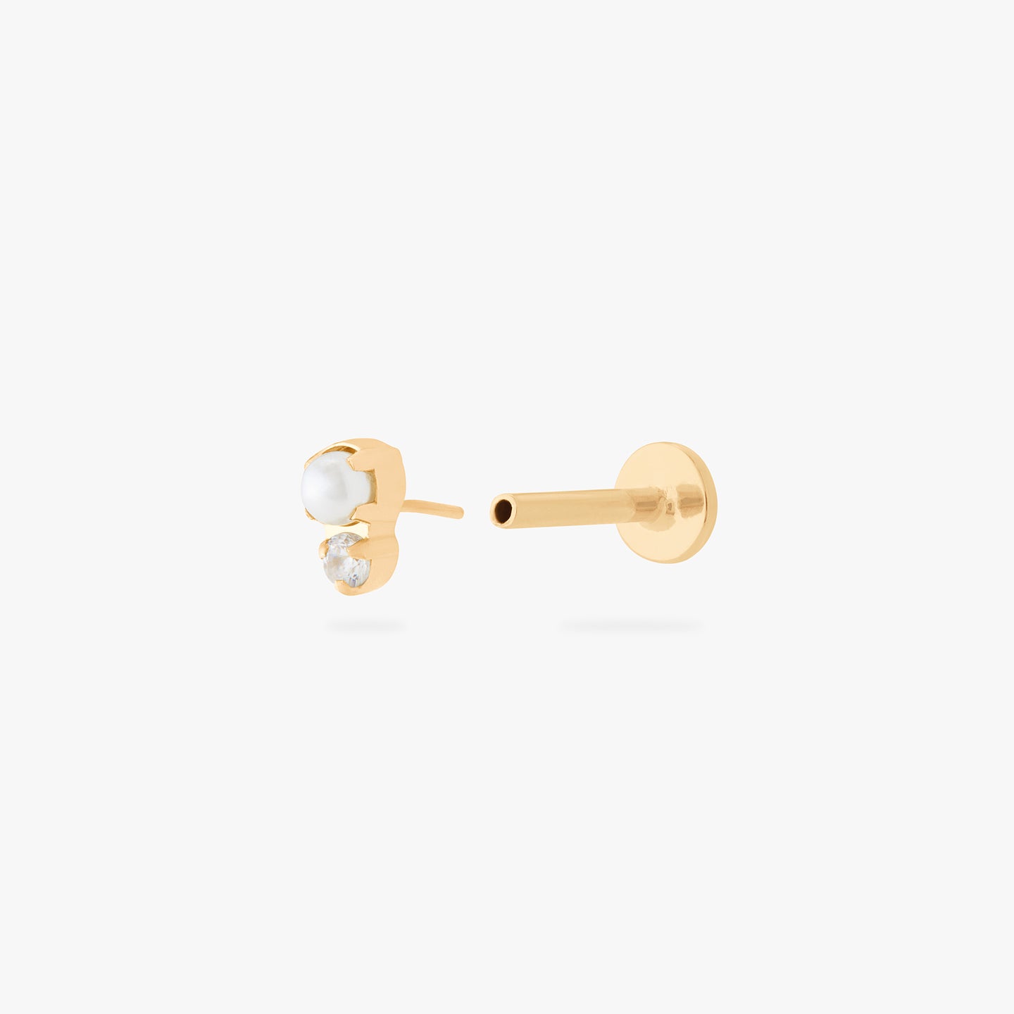 This is an image of a flatback top which has a pearl stacked over gold/clear CZ and then a gold labret that has a circle disc with the 