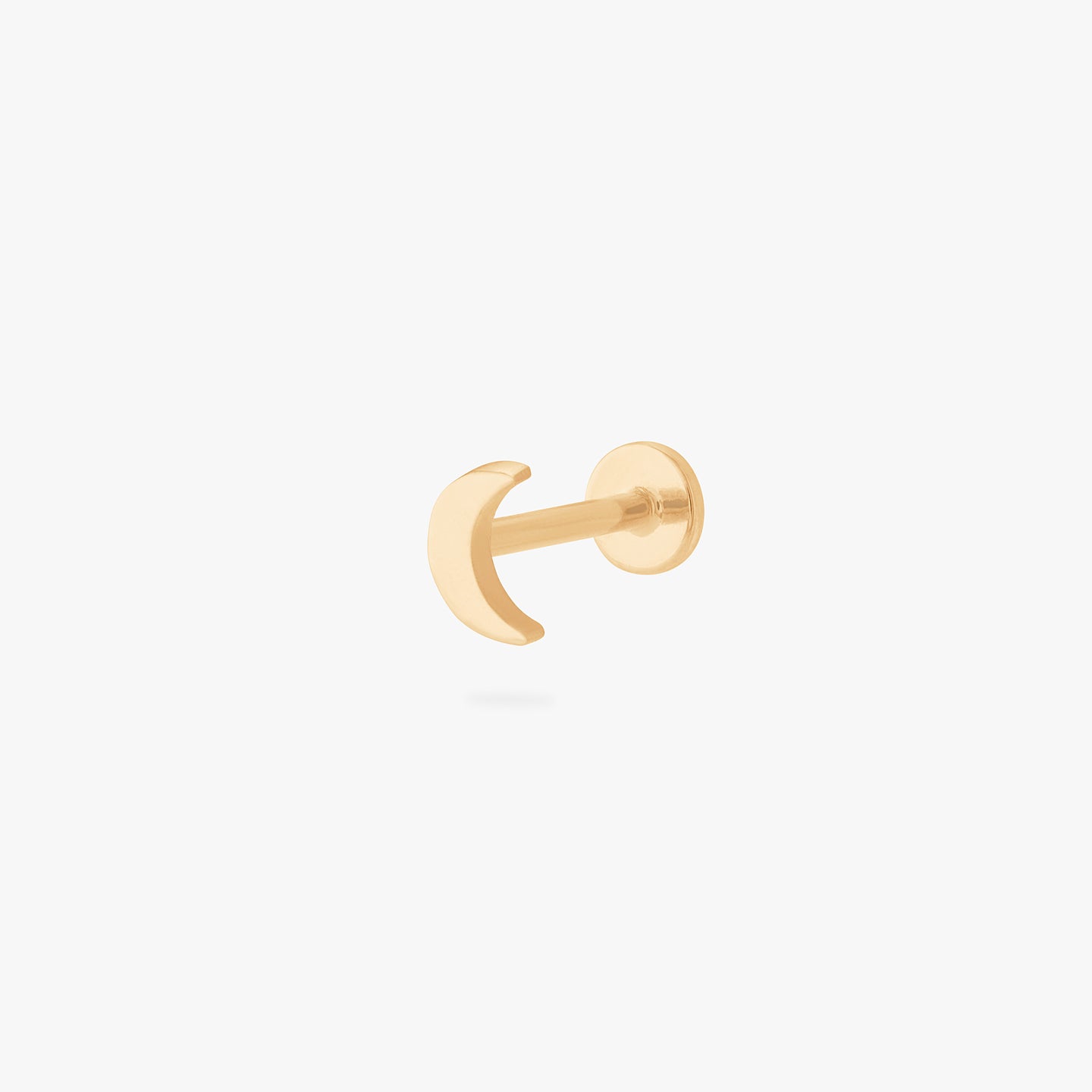 This is an image of a gold moon shaped flatback top with a gold labret with a circle disc with the 