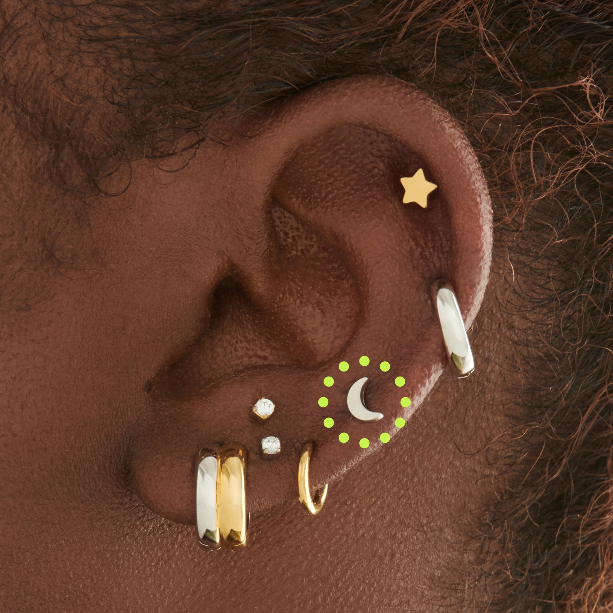 This is an image of a silver moon shaped flatback top with a silver labret with a circle disc with the "S" logo engraved in it. [hover] color:null|silver