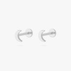 This is an image of a pair of silver moon shaped flatback tops with silver labrets with circle discs with the "S" logo engraved in them. [pair] color:null|silver/clear|silver