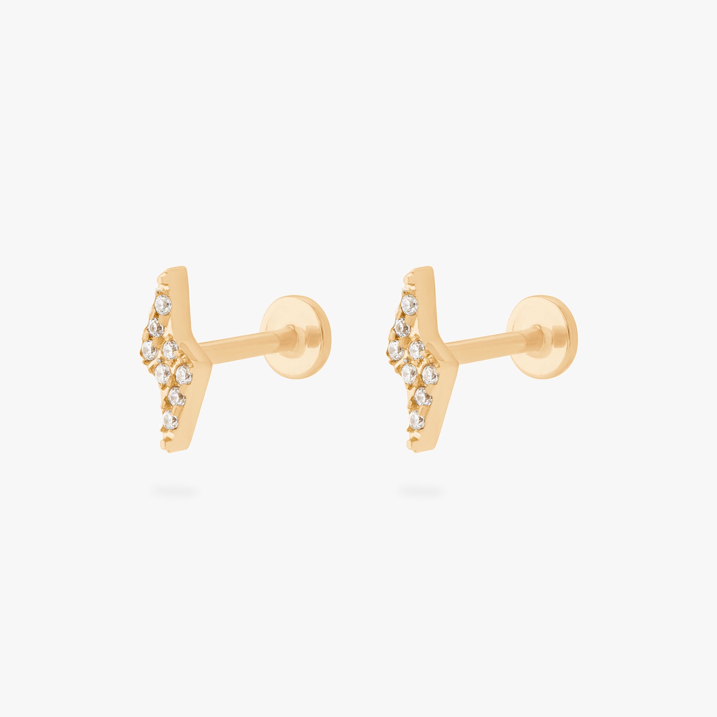 This is an image of a pair of gold/clear pave lightning-bolt shaped flatback tops with gold labrets with circle discs that have an 