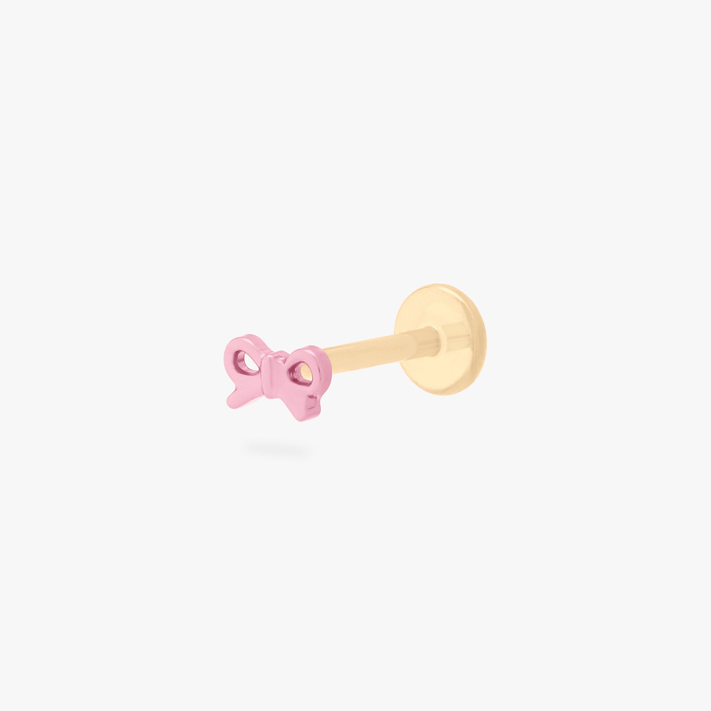 This image is of a pink bow-shaped flatback stud made out of titanium with a gold-toned labret back on. color:null|pink