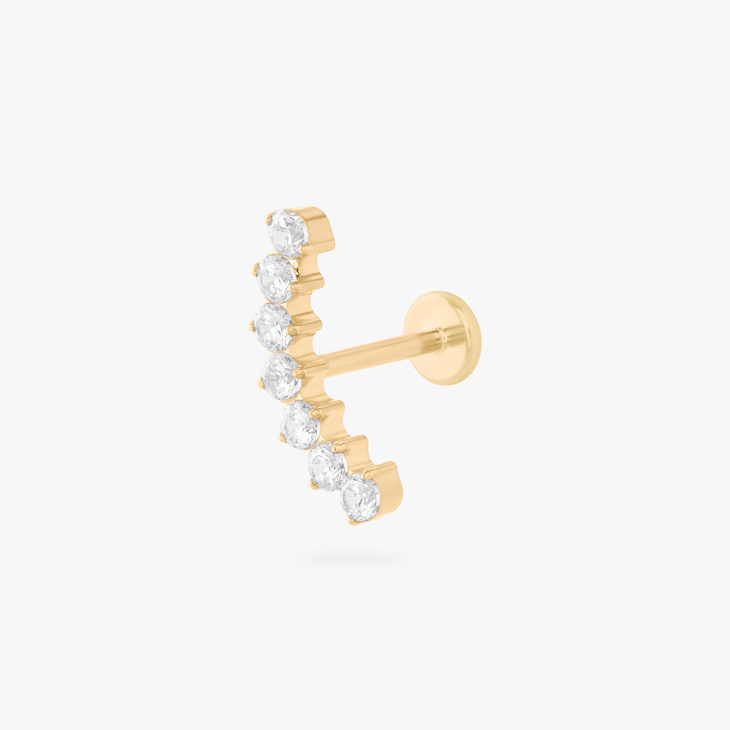 a flatback stud with a curved row of cz stones in gold color:null|gold/clear