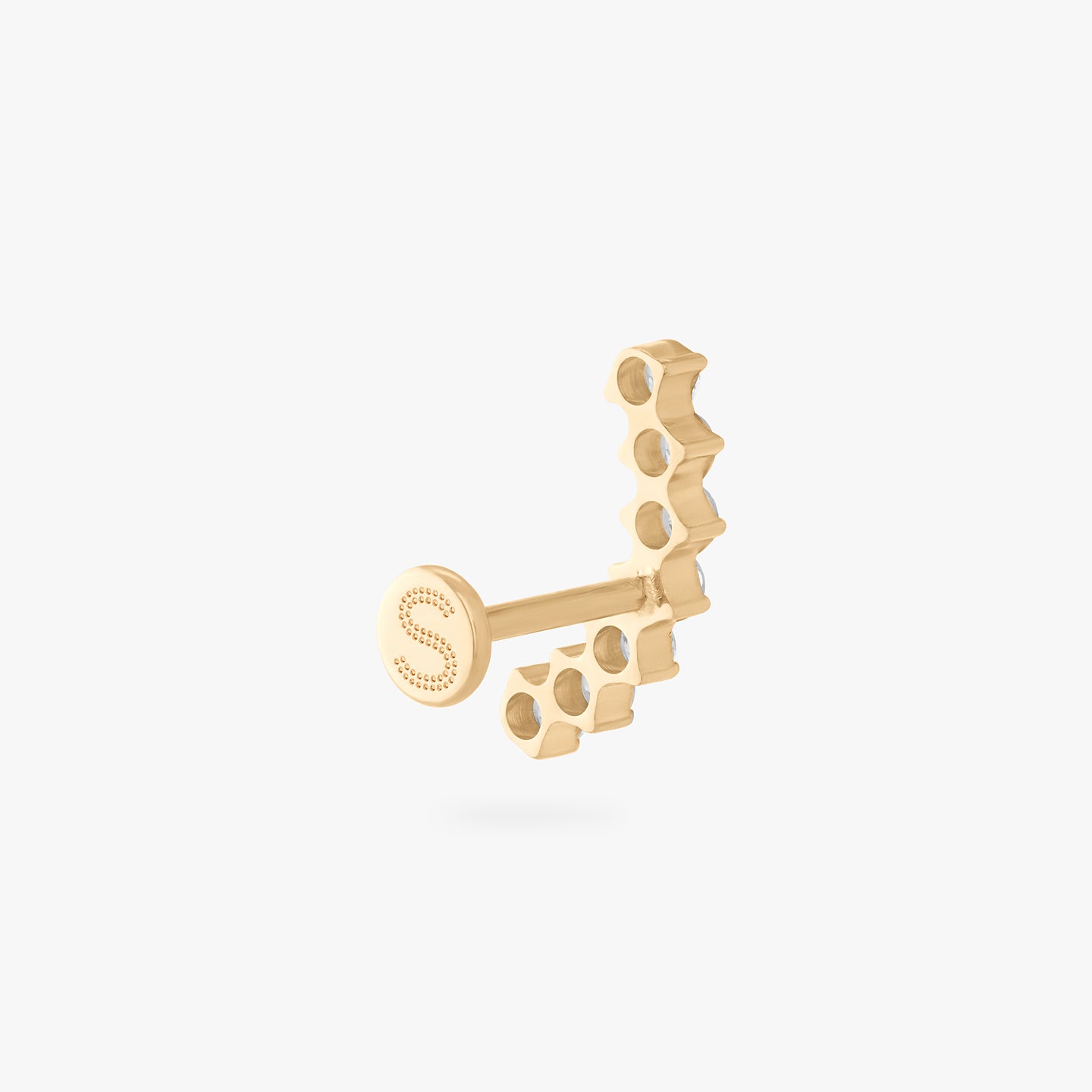 a flatback stud with a curved row of cz stones in gold color:null|gold/clear