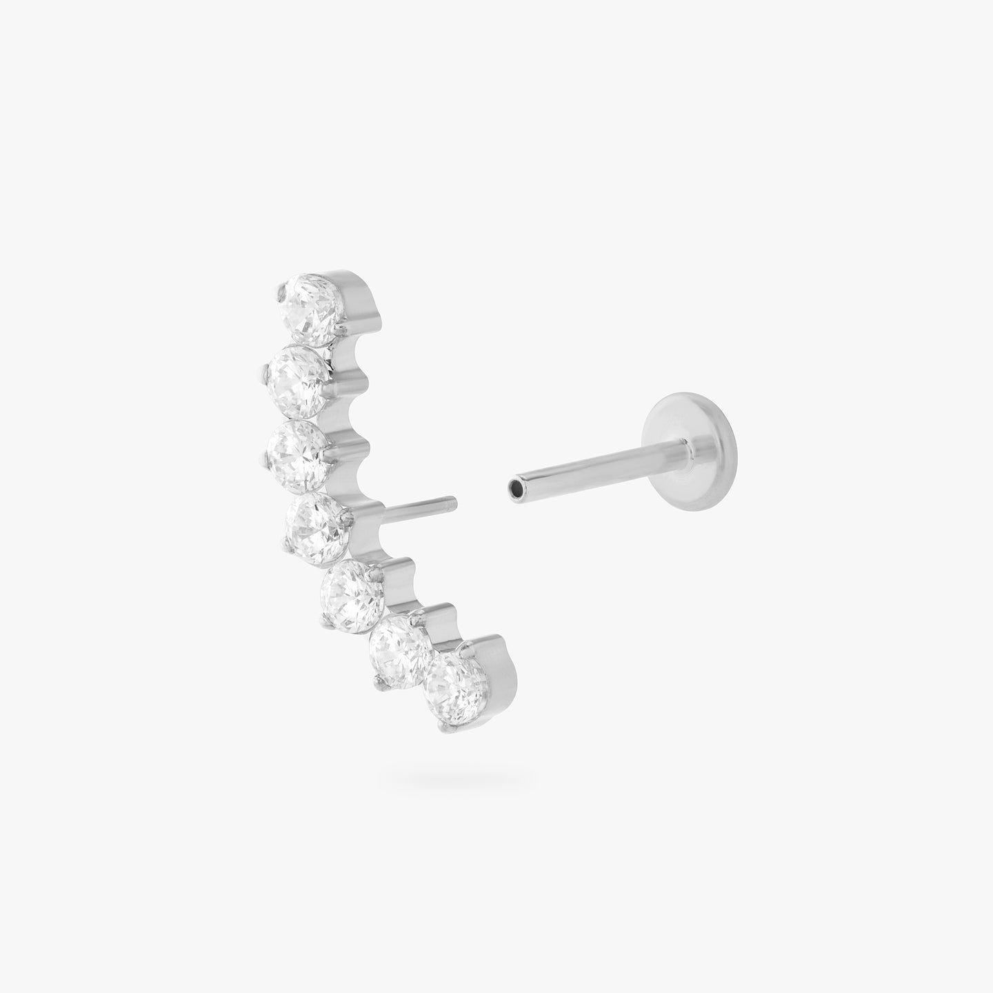 a flatback stud with a curved row of cz stones in silver color:null|silver/clear