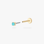 Gold stud flatback earring with a micro light blue cz gemstone on a white background