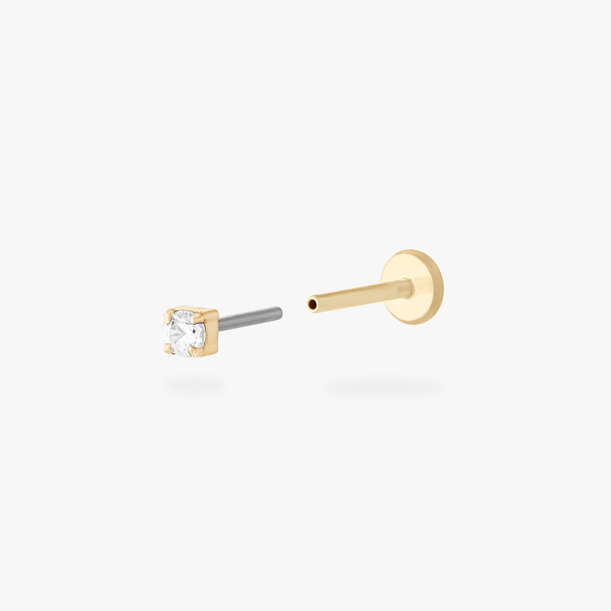 This is an image of a 14K yellow gold PVD plated titanium flatback stud with a clear CZ stone.