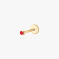 Gold flatback earring with a micro red gemstone on a white background