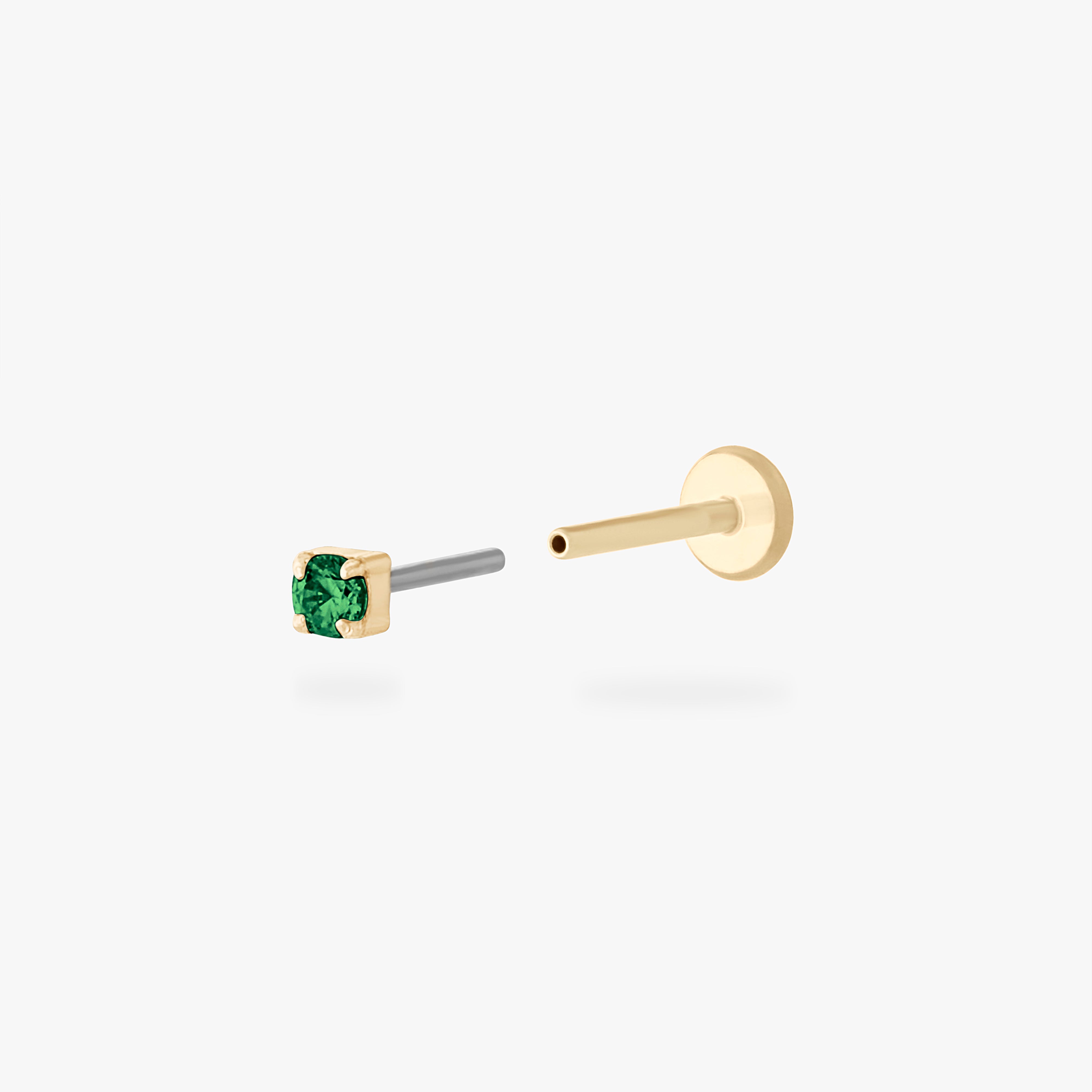 This is an image of a 14K yellow gold PVD plated titanium flatback stud with a green CZ stone. - Alternative view 2