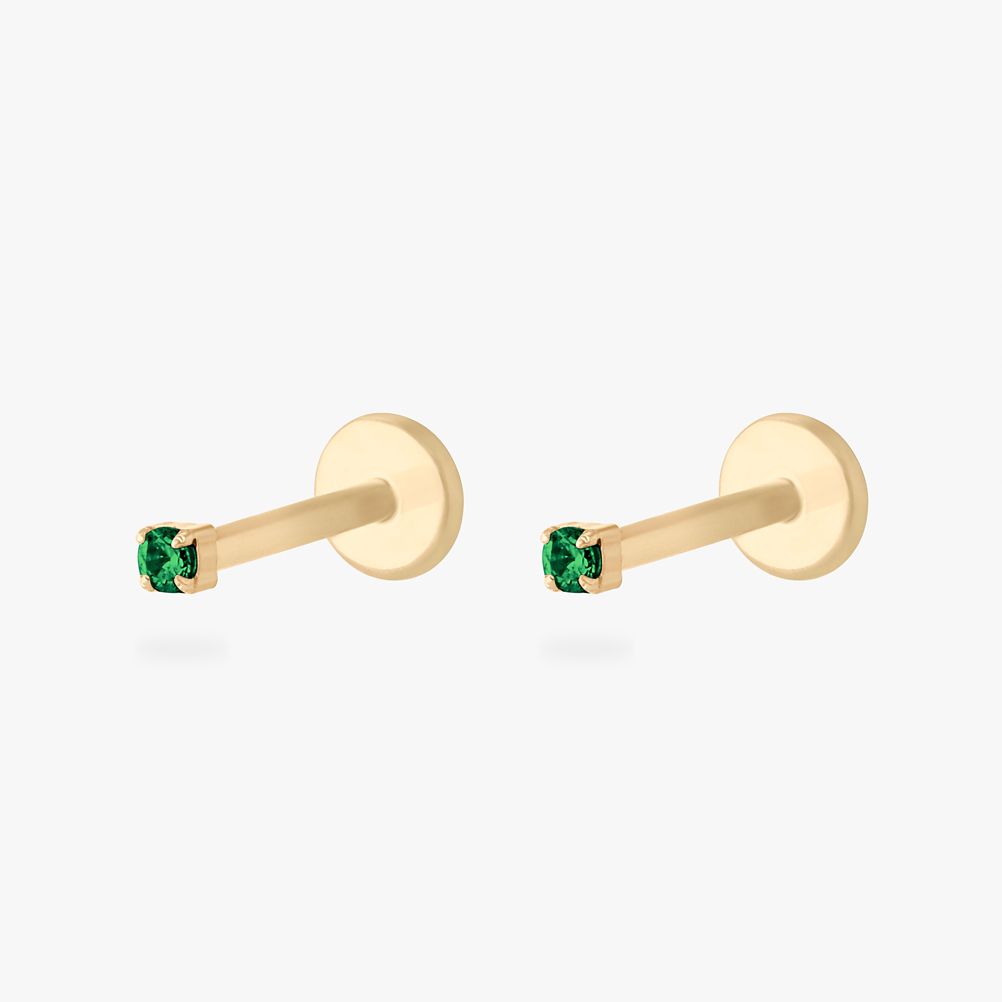 This is an image of a 14K yellow gold PVD plated titanium flatback stud with a green CZ stone. This image displays a pair of these flatback studs. - Pair view