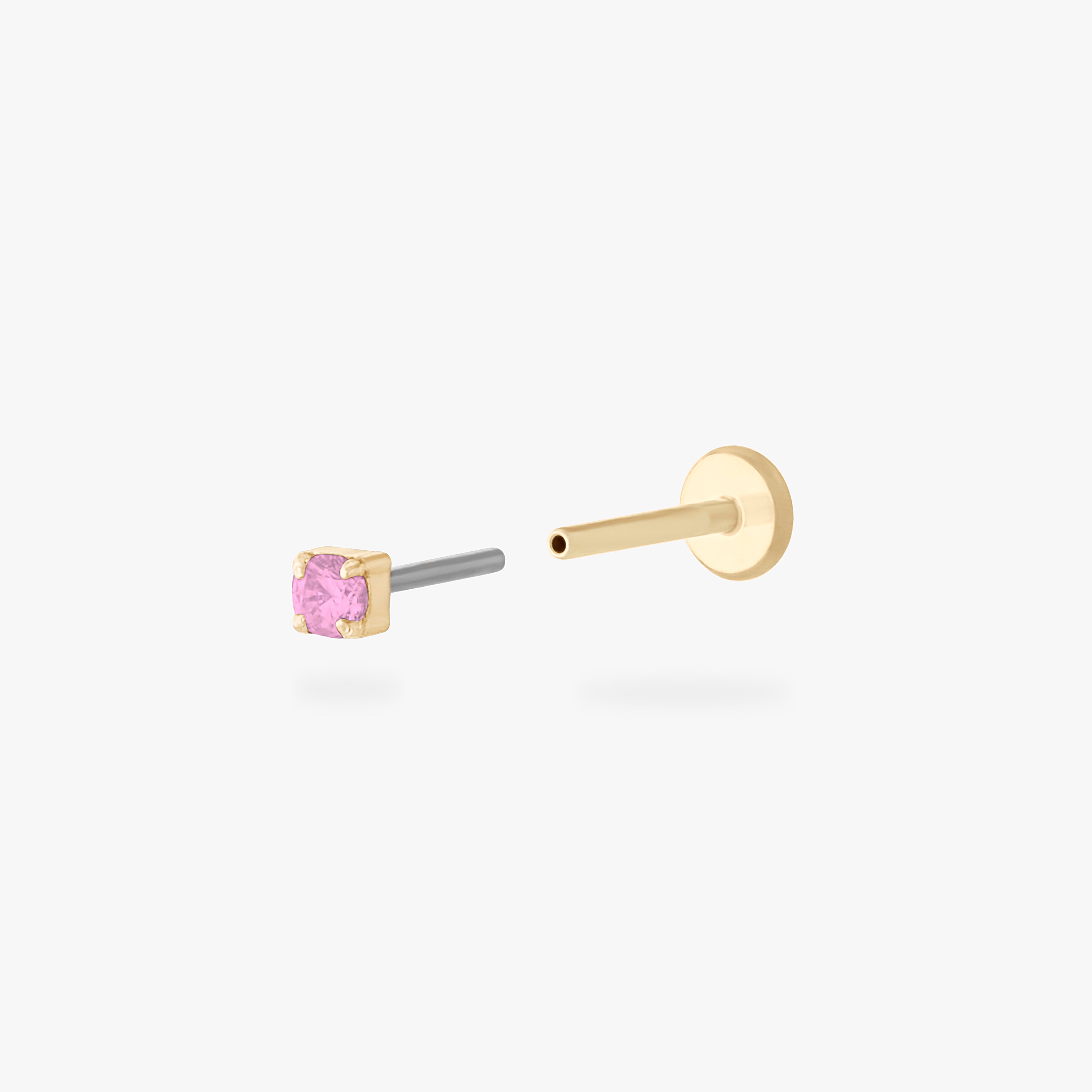 This is an image of a 14K yellow gold PVD plated titanium flatback stud with a pink CZ stone. - Alternative view 2