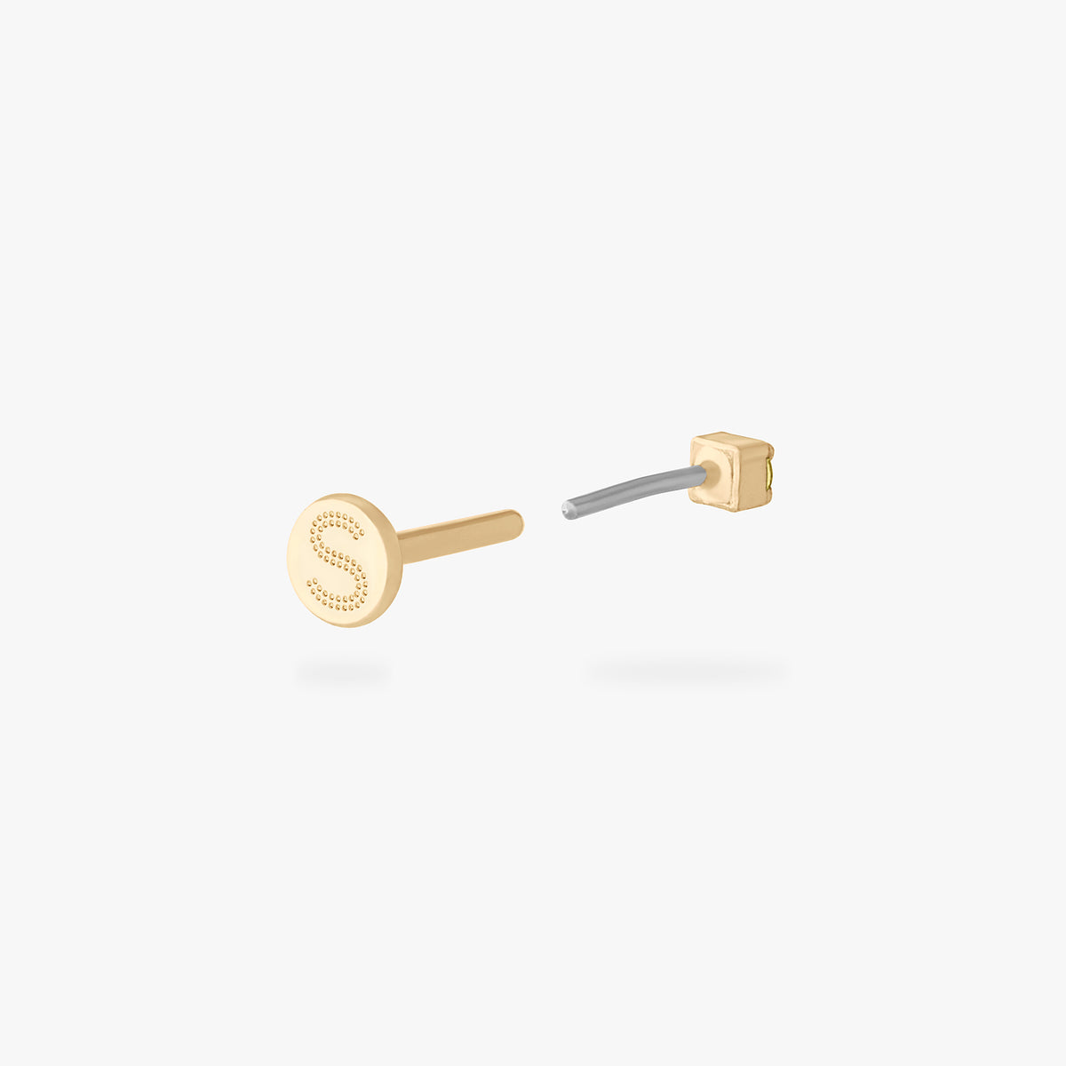 Gold micro CZ flatback stud earring with engraved letter S on the backing shown from back angle with flat backing visible