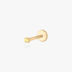 This is an image of a gold toned titanium flatback stud with a micro sized topaz CZ stone against a white background. 