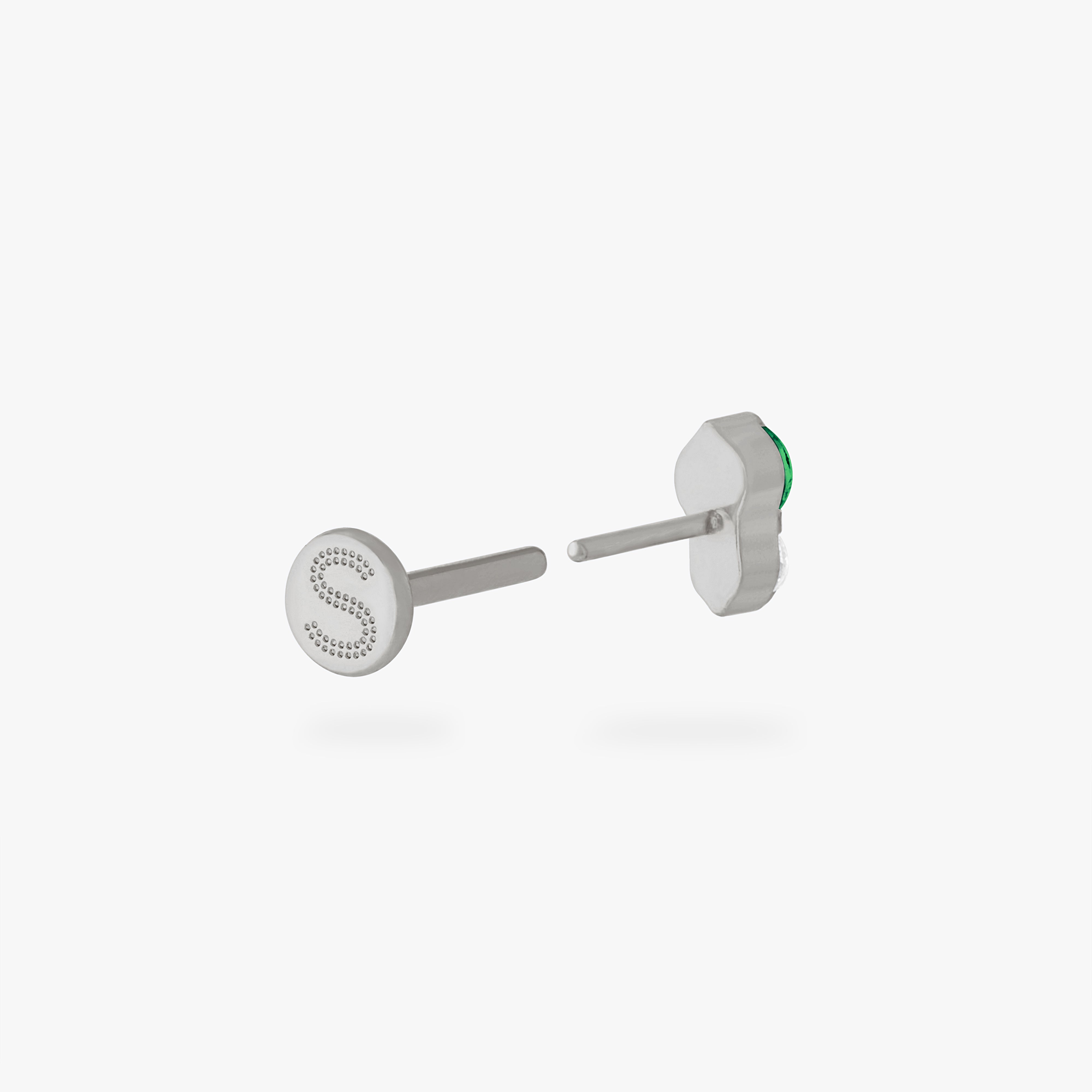 This is an image of a silver flatback stud composed of titanium with a green cz stone stacked over a clear cz stone. color:null|silver/green
