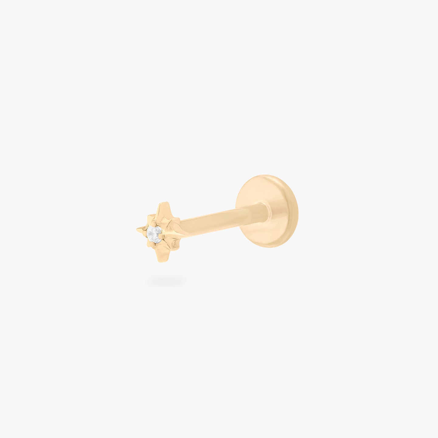 This is an image of a gold-toned flatback stud that is in the shape of a twinkle star with a clear CZ in the middle. color:null|gold/clear