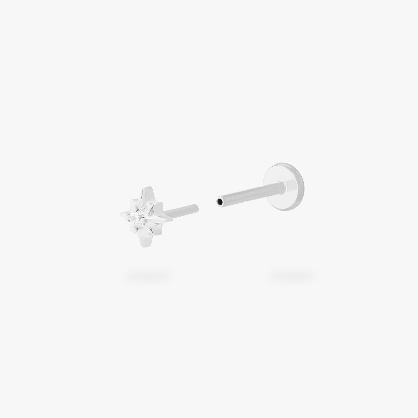 This is an image of a silver-toned flatback stud that is in the shape of a twinkle star with a clear CZ in the middle. color:null|silver/clear