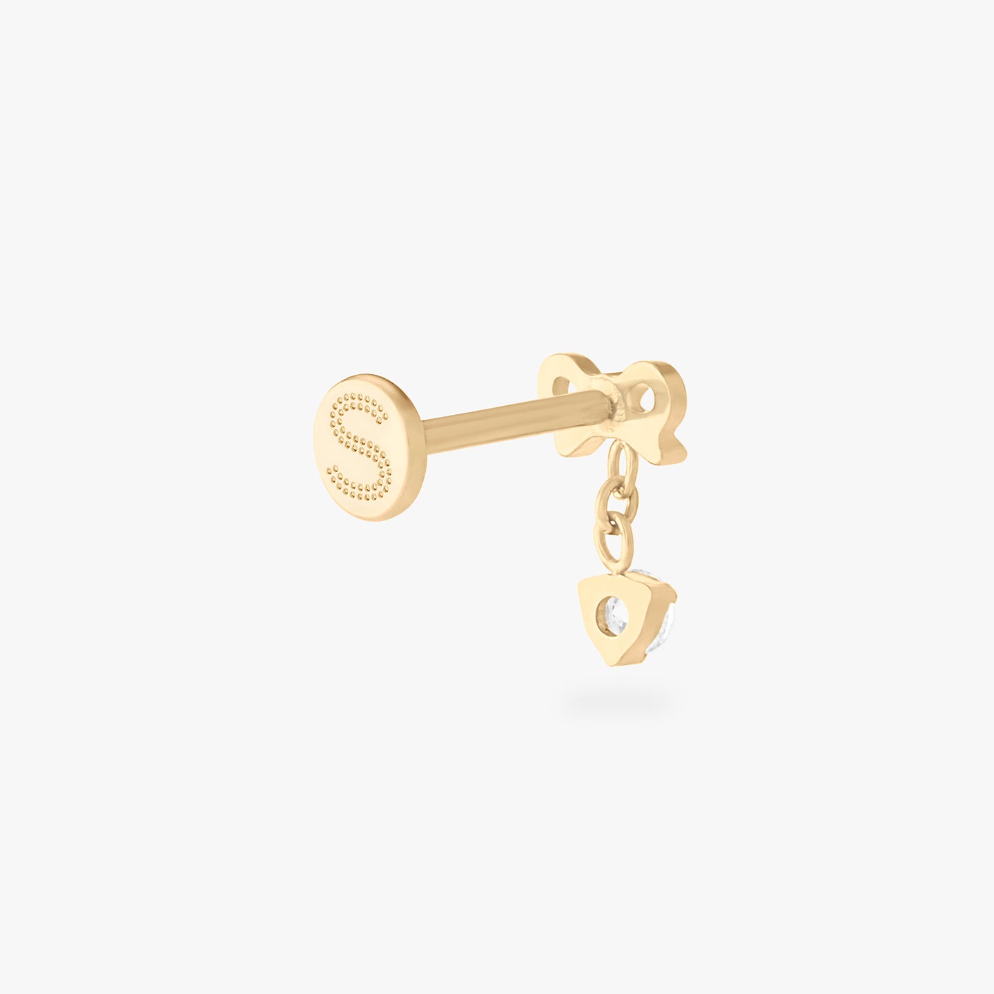 This is an image of a gold-toned flatback stud with a bow that a chain with a CZ dangles from. color:null|gold/clear