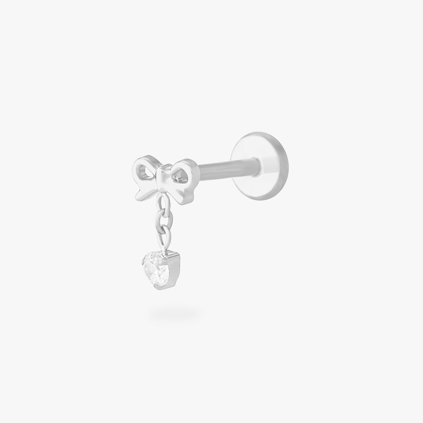 This is an image of a silver-toned flatback stud with a bow that a chain with a CZ dangles from. color:null|silver/clear