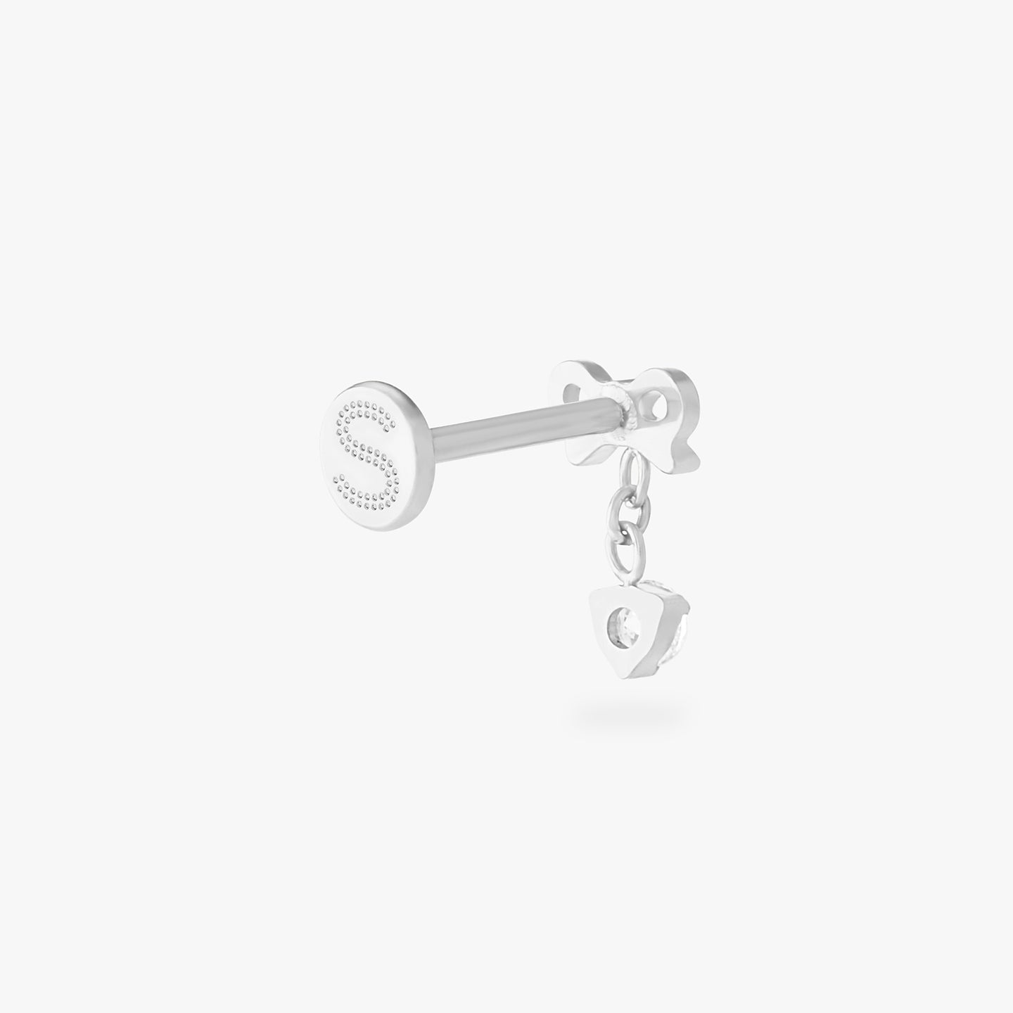 This is an image of a silver-toned flatback stud with a bow that a chain with a CZ dangles from. color:null|silver/clear