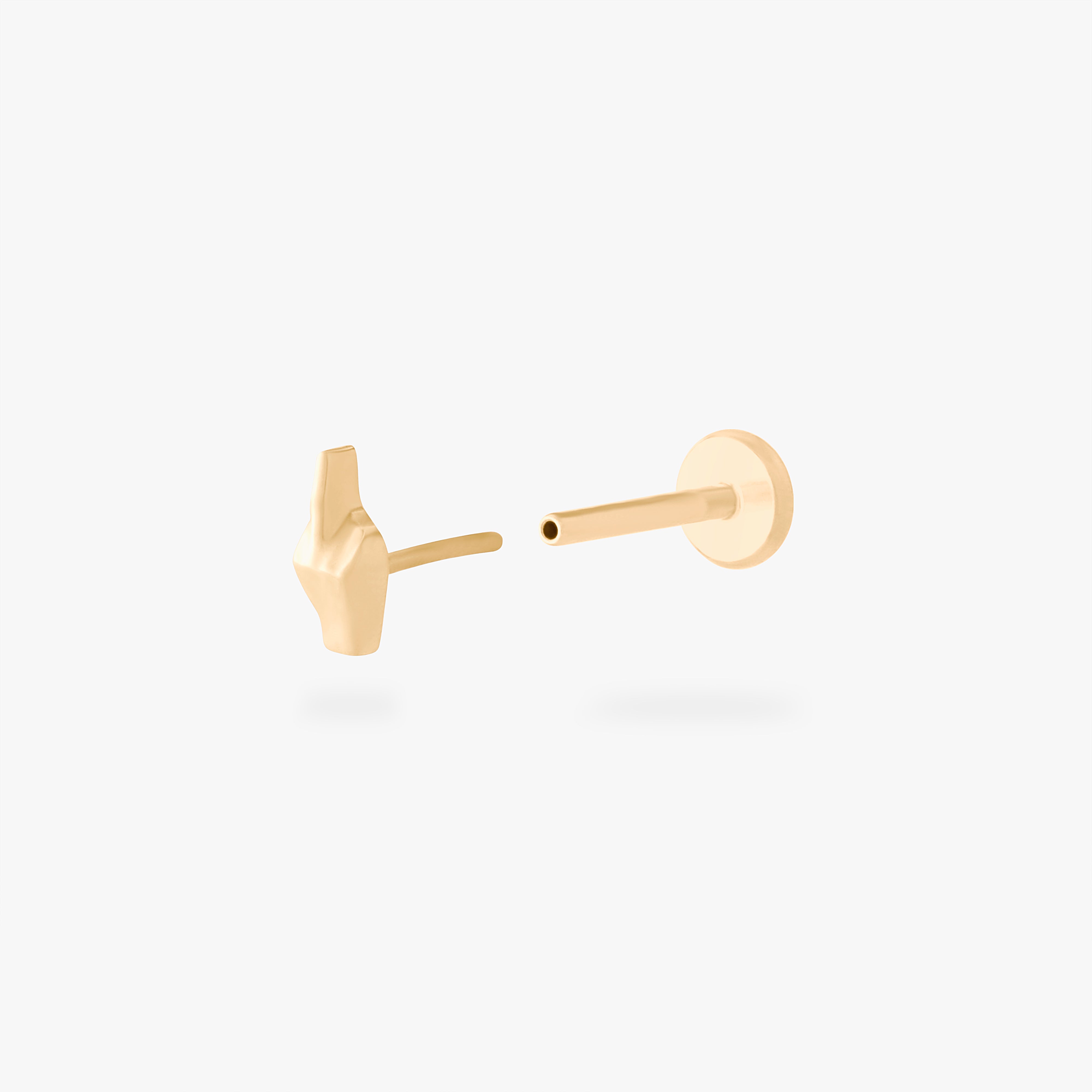 This is an image of a gold-toned flatback stud that is in the shape of a middle finger. color:null|gold