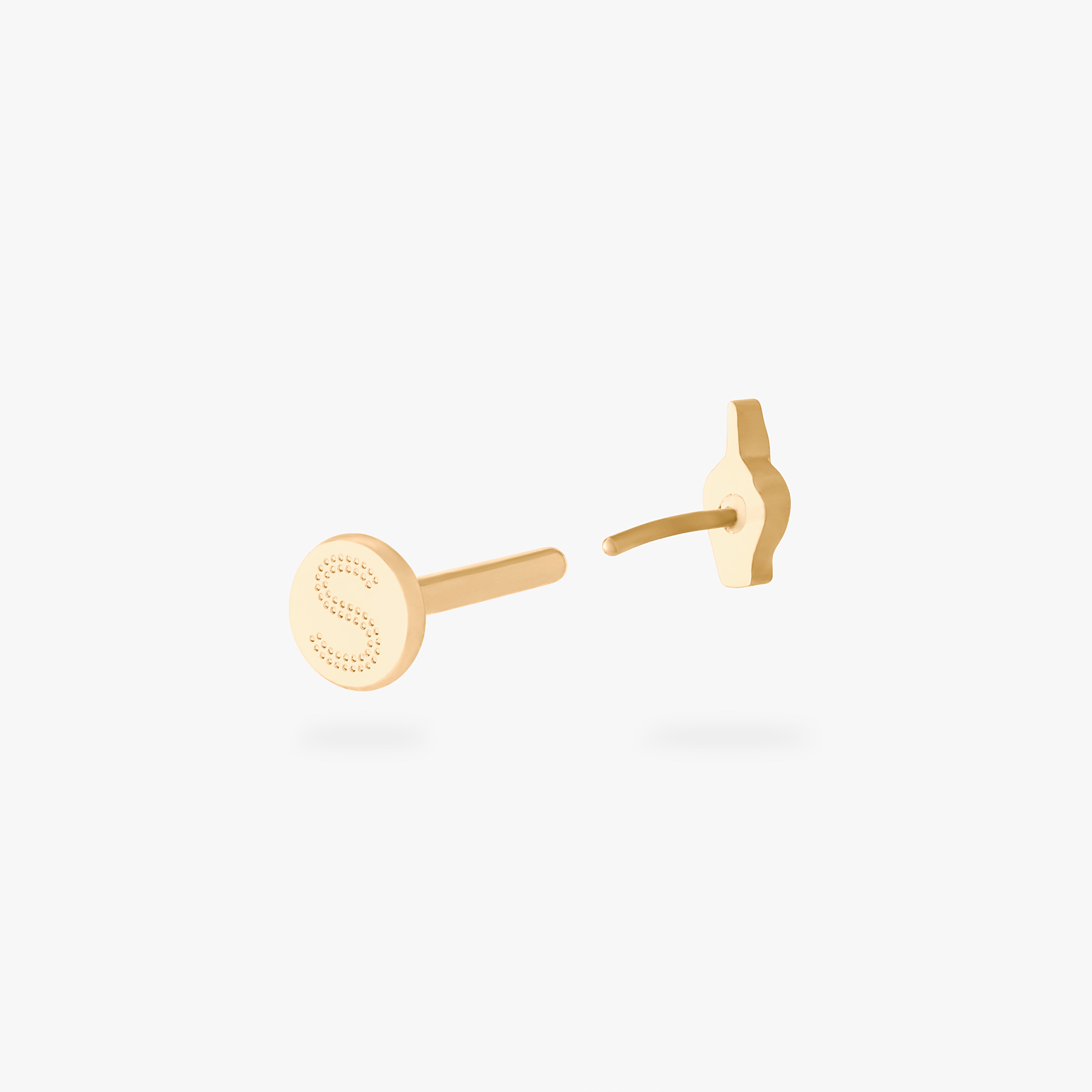 This is an image of a gold-toned flatback stud that is in the shape of a middle finger. color:null|gold
