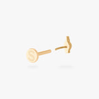This is an image of a gold-toned flatback stud that is in the shape of a middle finger. color:null|gold