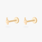 This is an image of a pair of gold-toned flatback studs that are in the shape of middle fingers. [pair] color:null|gold
