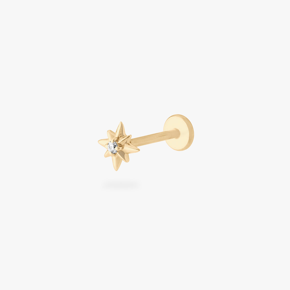 This is an image of a 14K gold flatback stud with a pointed star with a clear cz stone in the center. color:null|gold|gold/clear