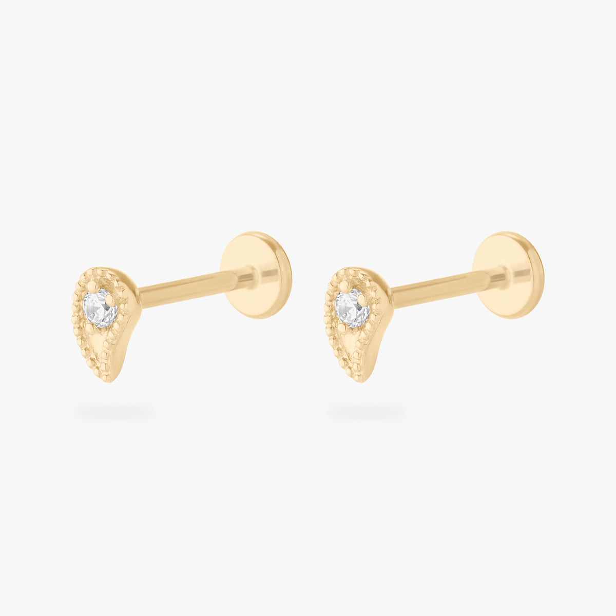 This image shows a pair of 14k Paisley flatback studs with a cz clear stone in the middle.