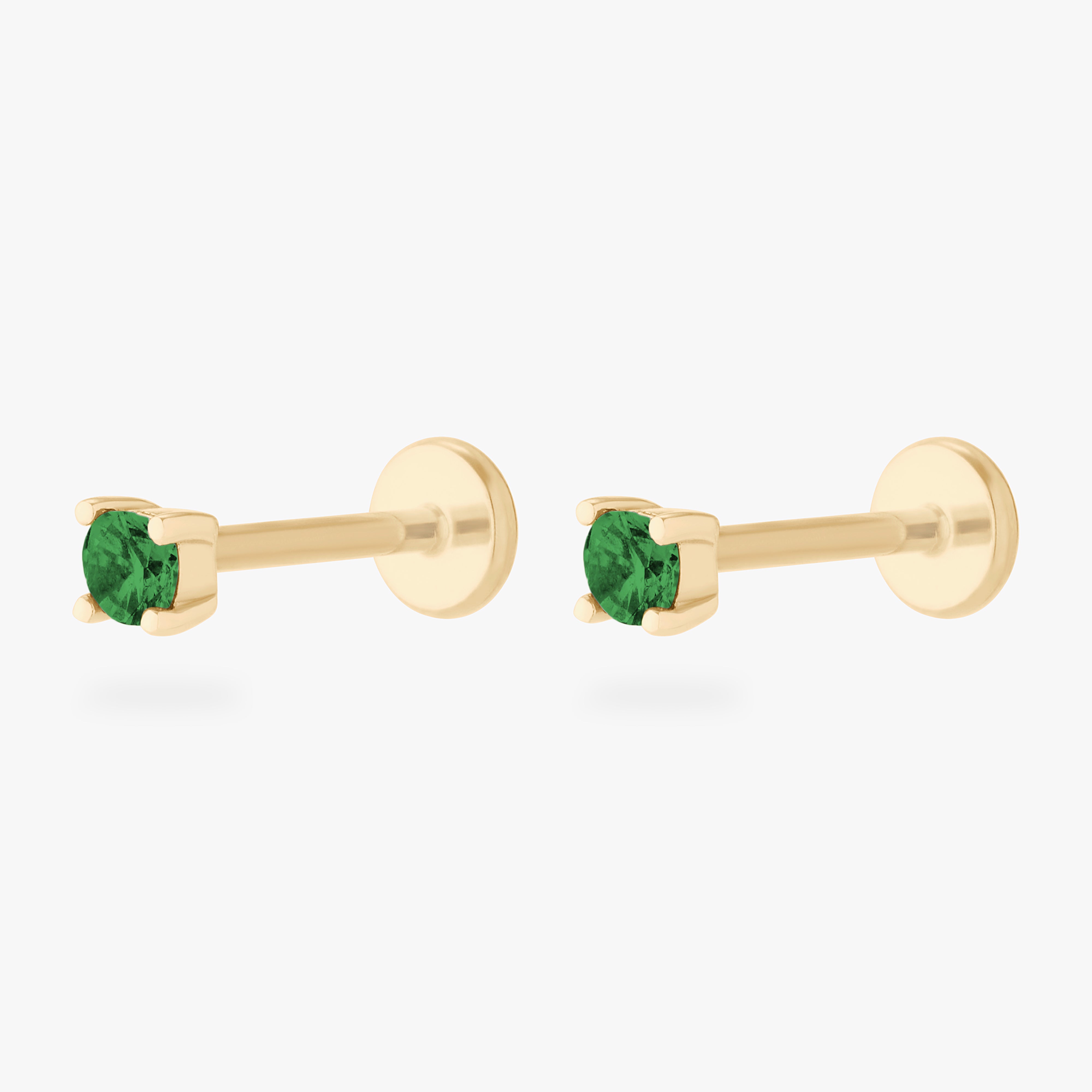 This is an image of a pair of 14k gold flatbacks with 2.5mm cz settings and green cz stones. [pair] color:null|14k gold|14k gold/green
