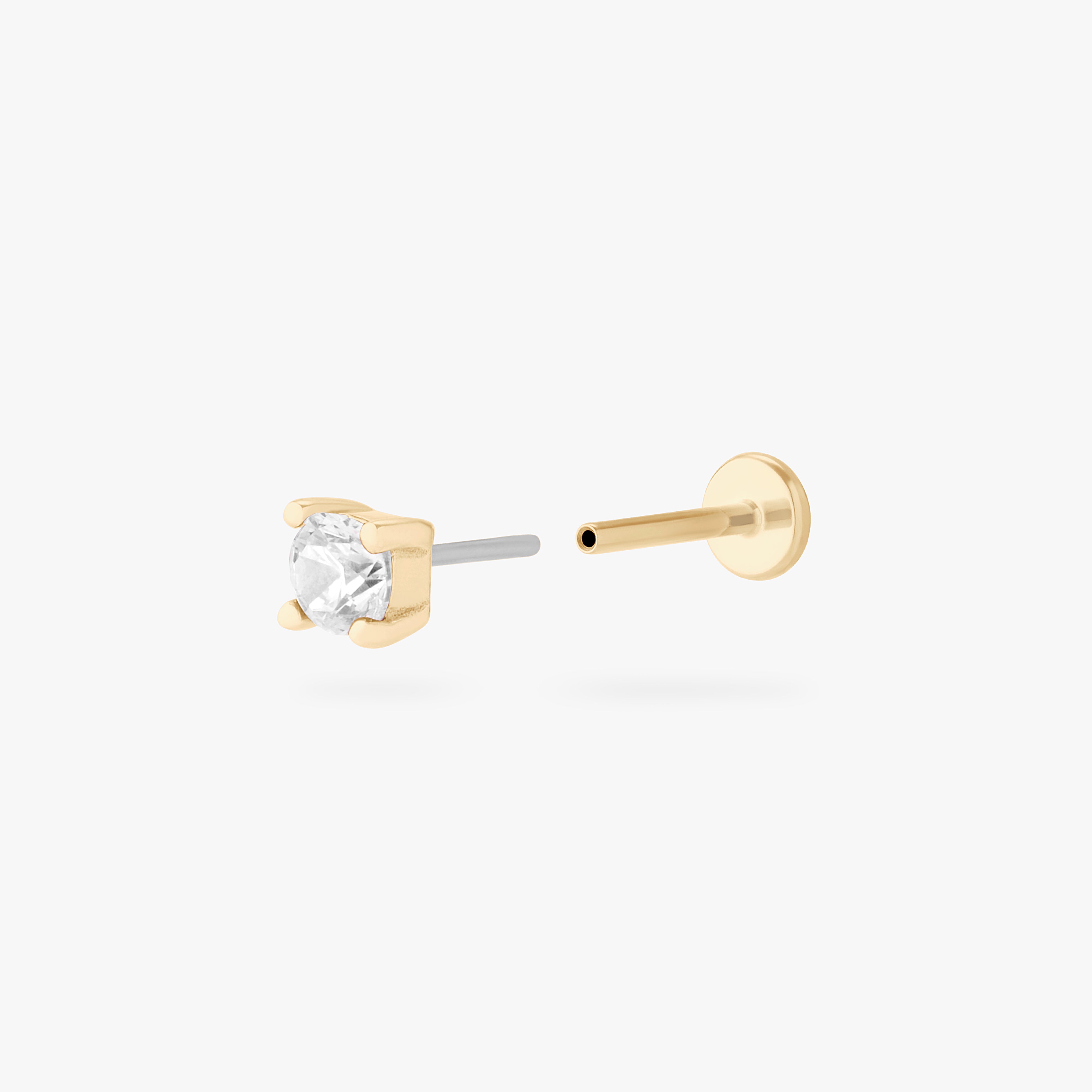 a clear mini cz stud set in a 14k gold setting color:null|gold/clear