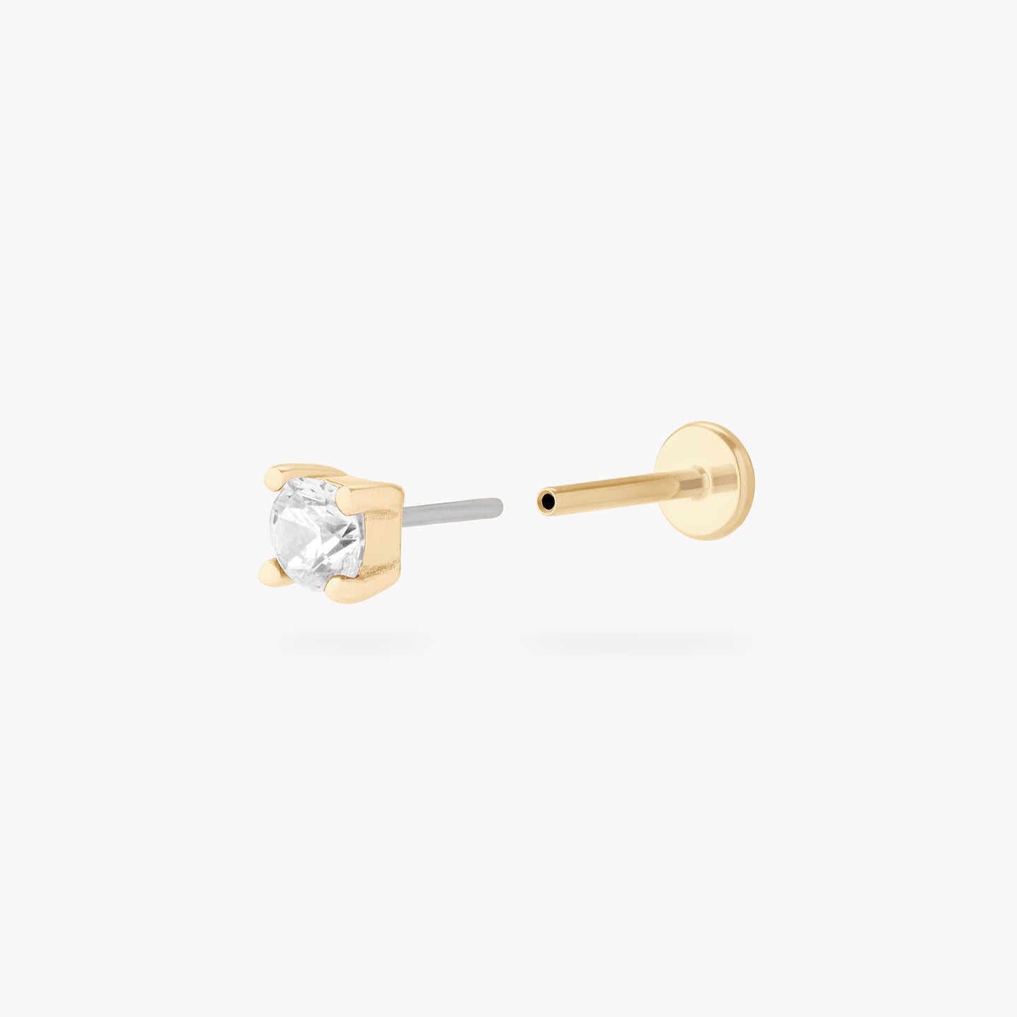 a clear mini cz stud set in a 14k gold setting color:null|gold/clear