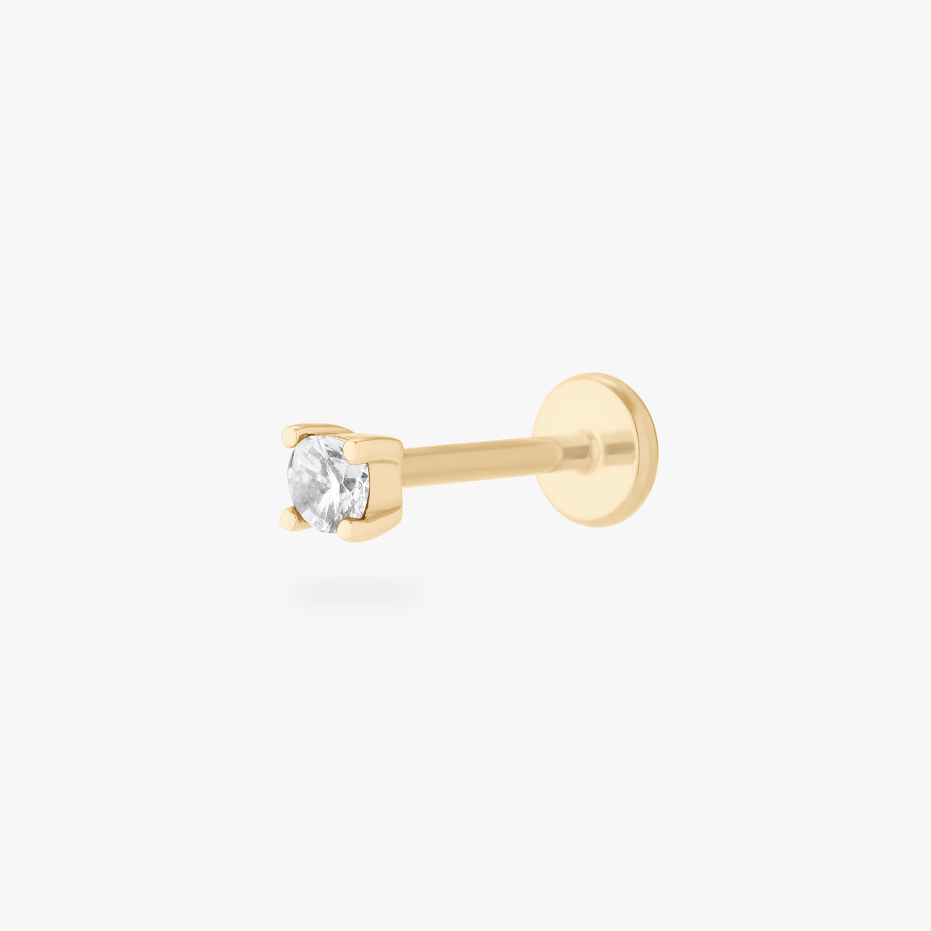 a clear mini cz stud set in a 14k gold setting color:null|gold/clear