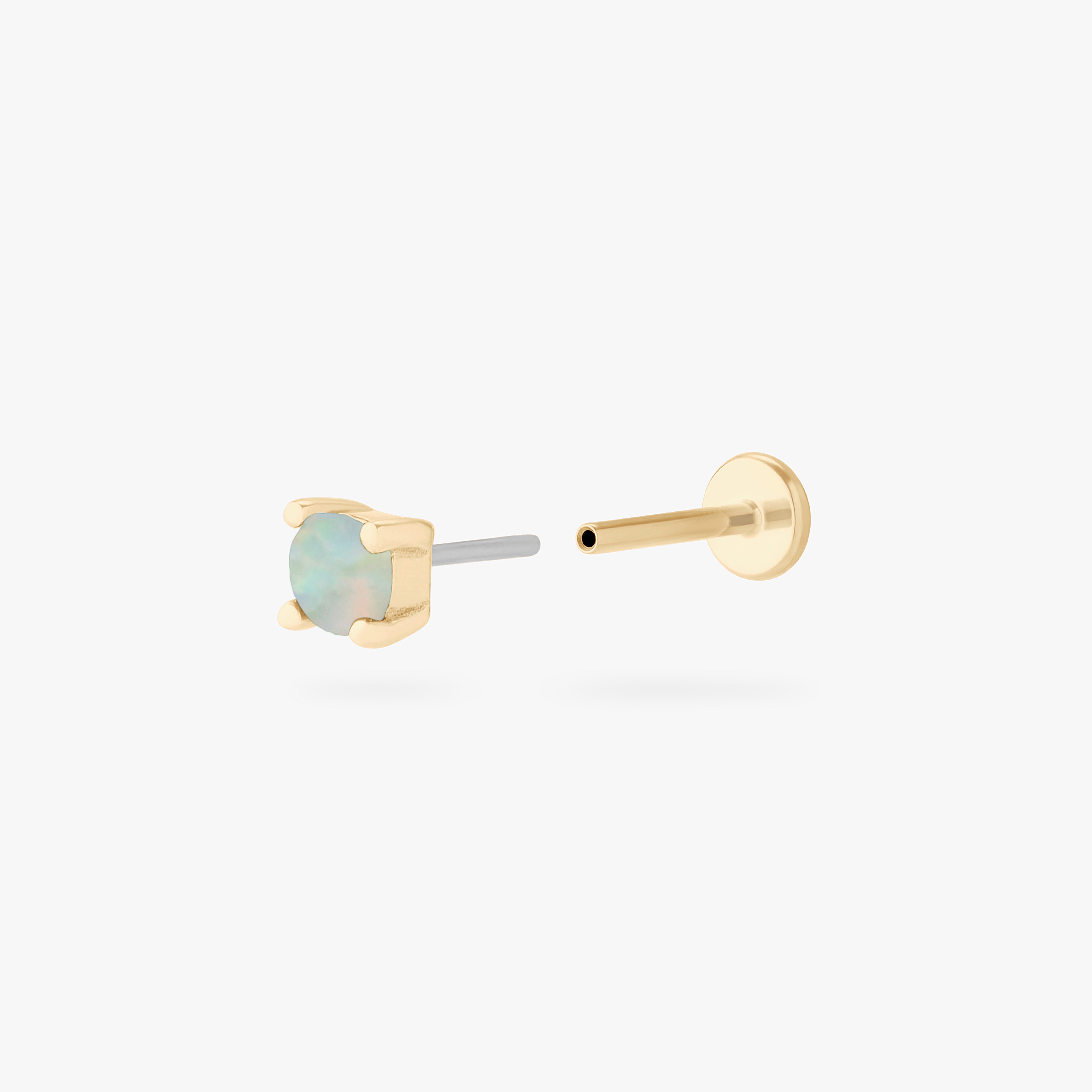 This is an image of a 14k gold flatback with an opal stone. color:null|14k gold