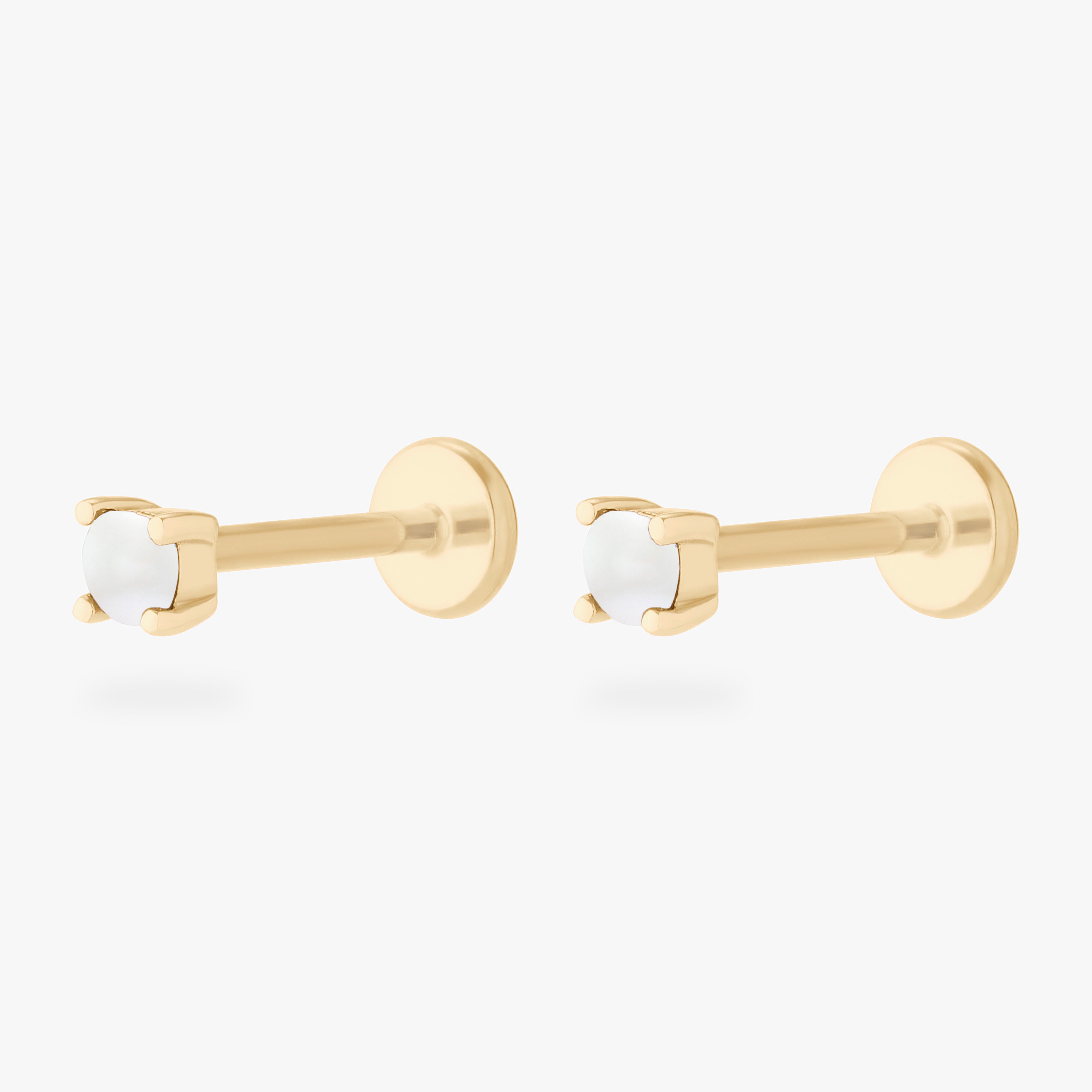 This is an image of a pair of 14k gold flatbacks with pearl stones. [pair] color:null|14k gold