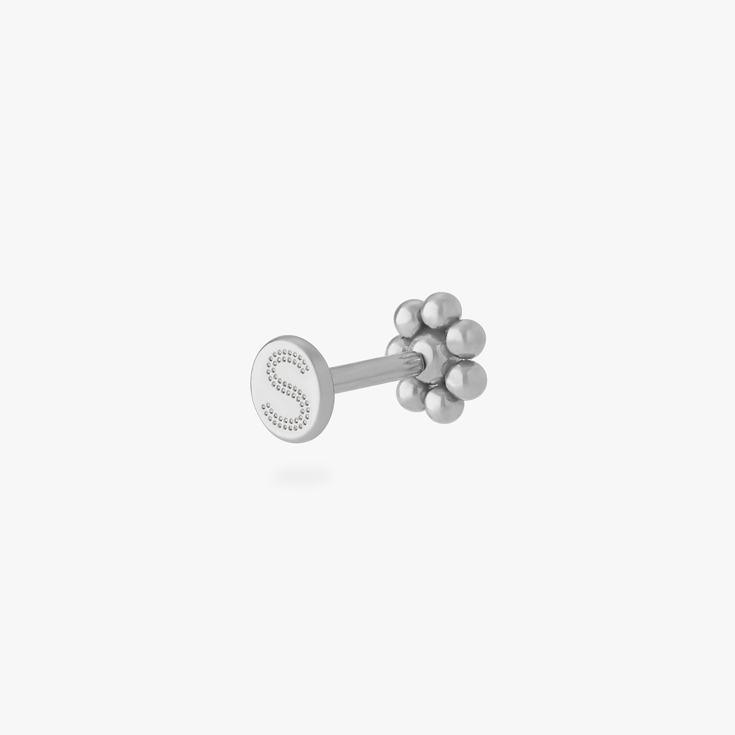 a small flower-shaped titanium flatback stud color:null|titanium