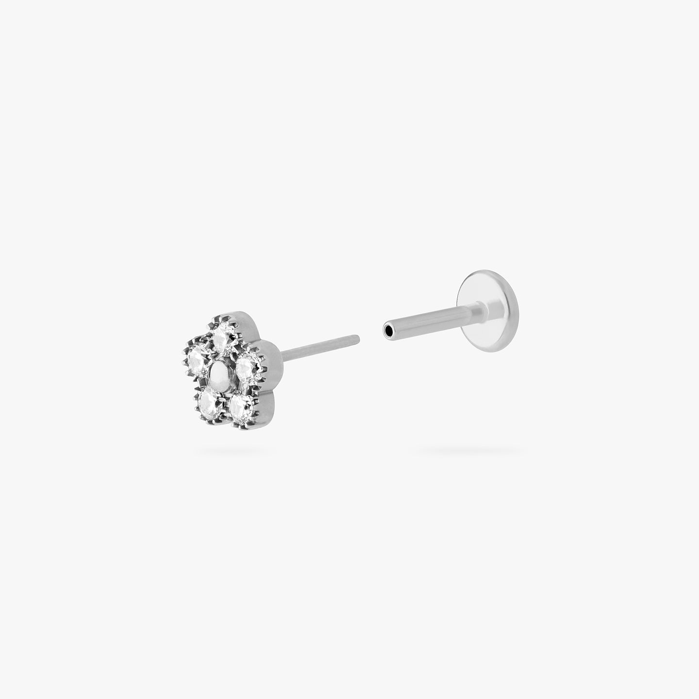 This is a silver titanium stud in the shape of a daisy made with 5 petal CZs color:null|titanium/clear