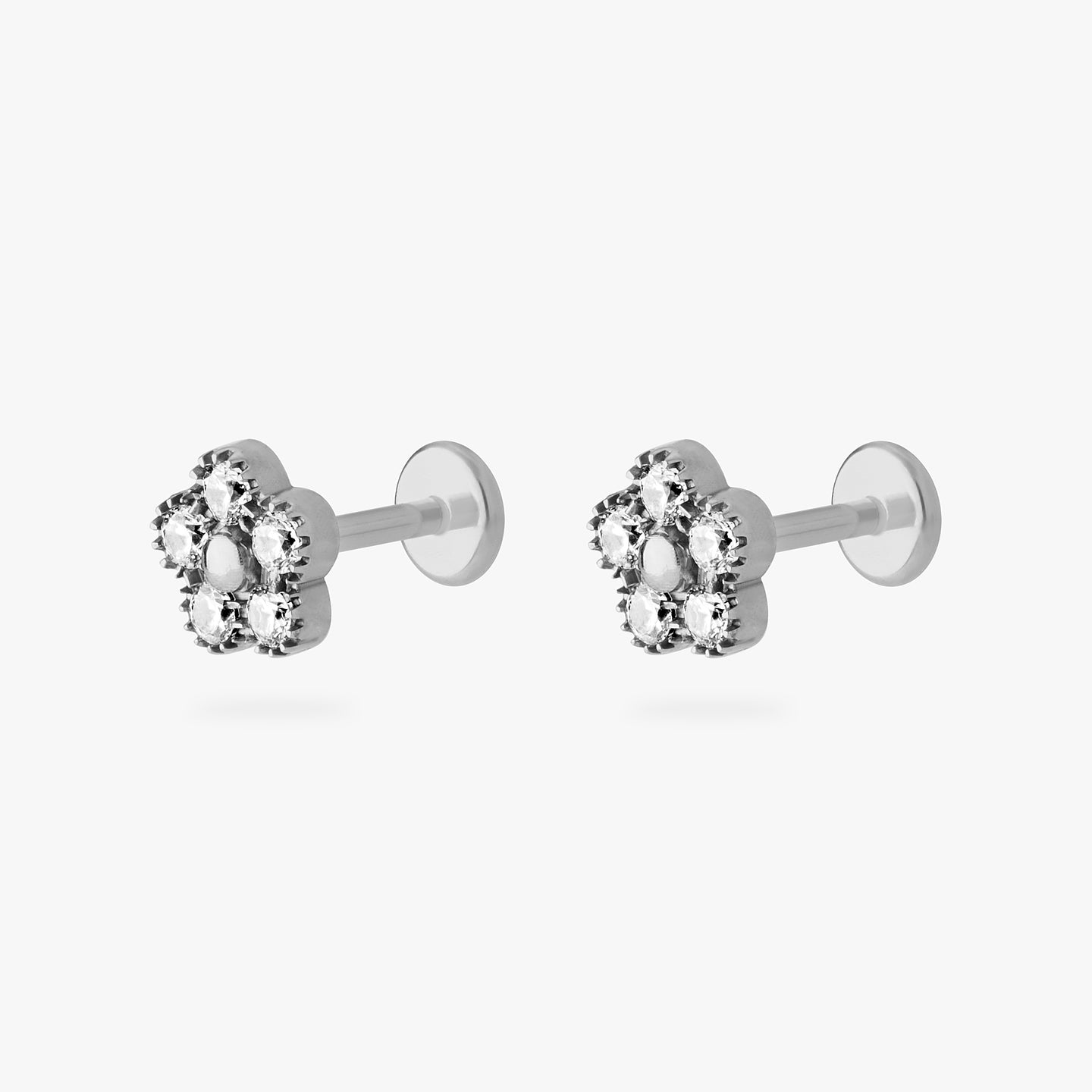 This is a silver titanium stud in the shape of a daisy made with 5 petal CZs [pair] color:null|titanium/clear