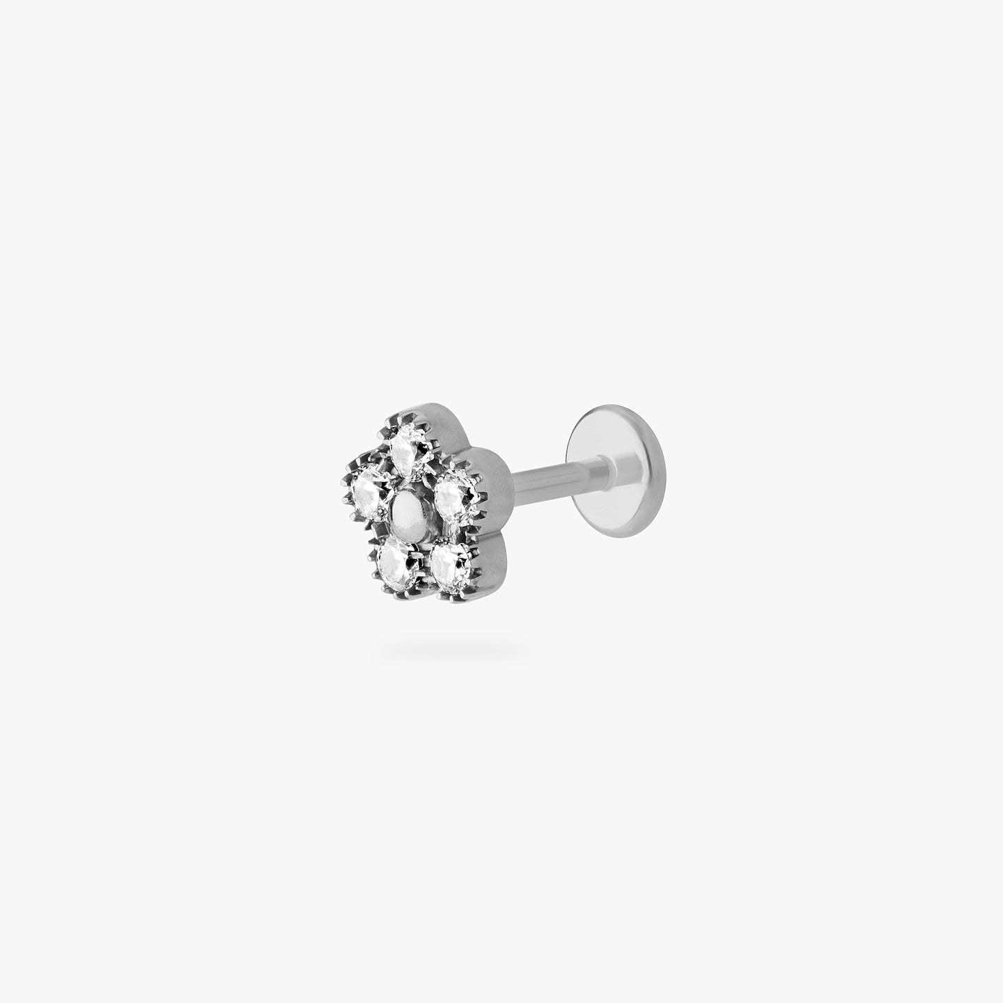 This is a silver titanium stud in the shape of a daisy made with 5 petal CZs color:null|titanium/clear