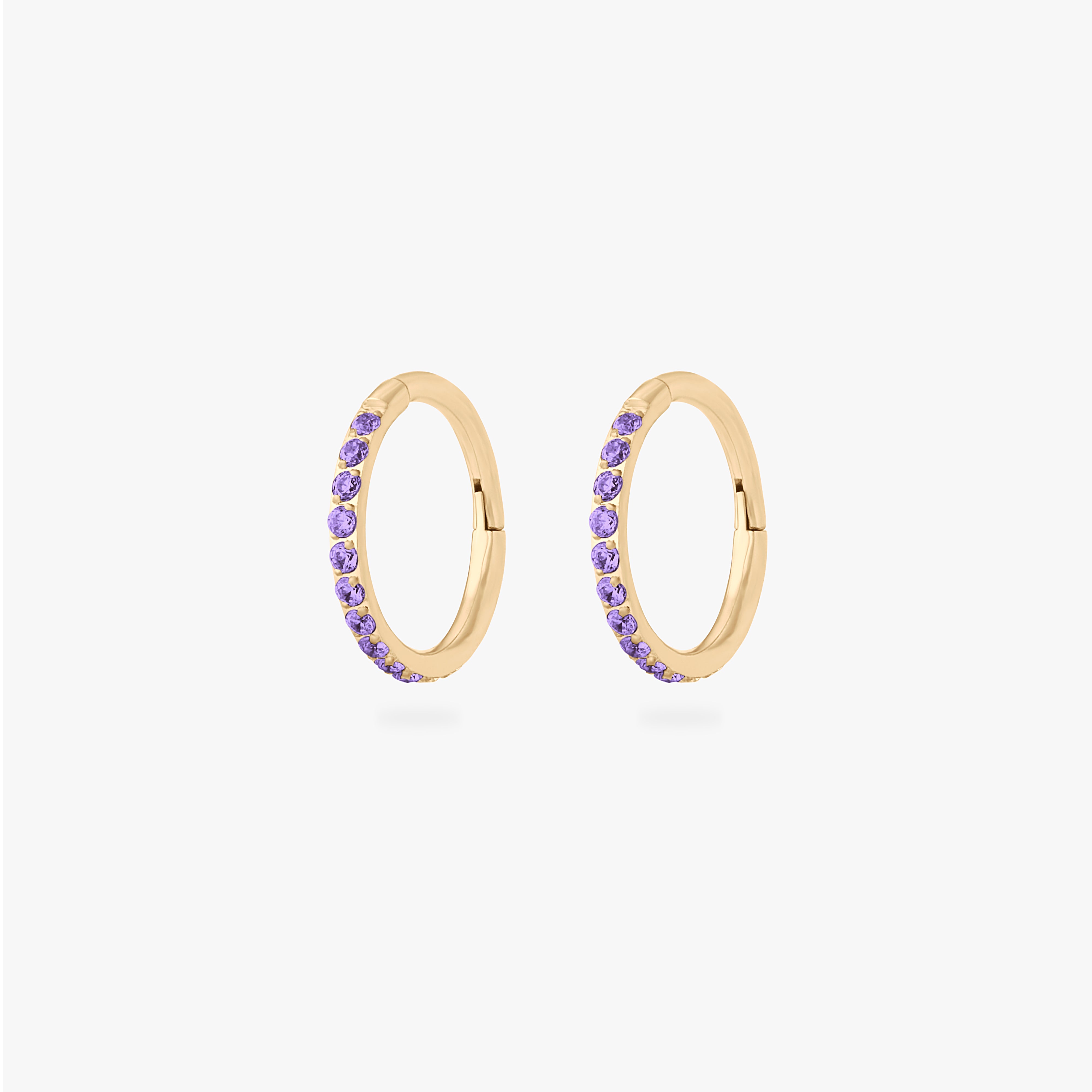 This is a pair of gold toned clickers with amethyst cz stones. [pair] color:null|amethyst