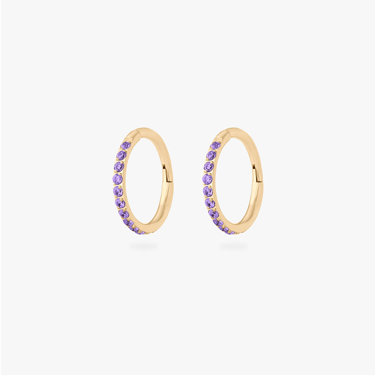 This is a pair of gold toned clickers with amethyst cz stones. [pair] color:null|amethyst