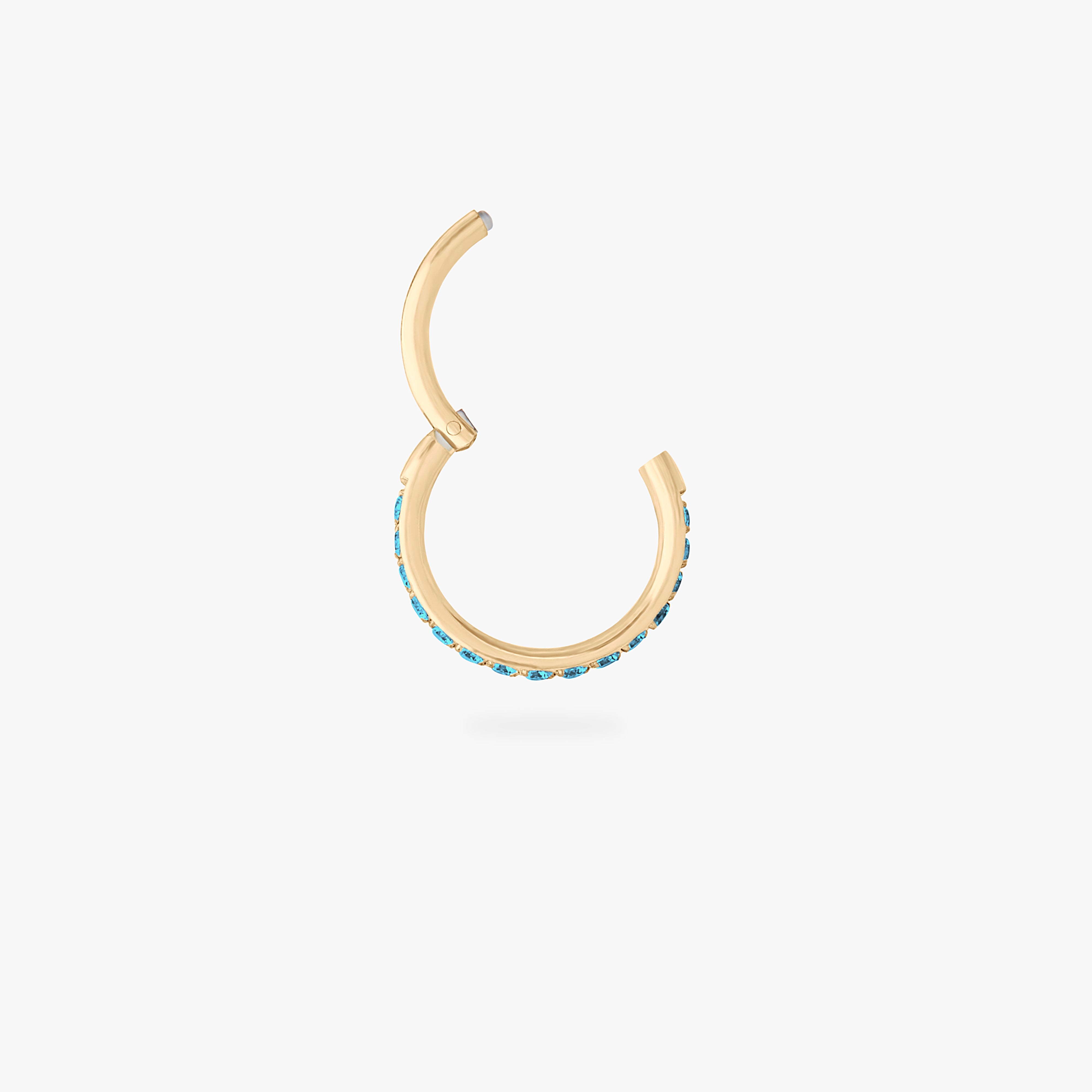 This is a gold toned clicker with aquamarine cz stones. color:null|aquamarine