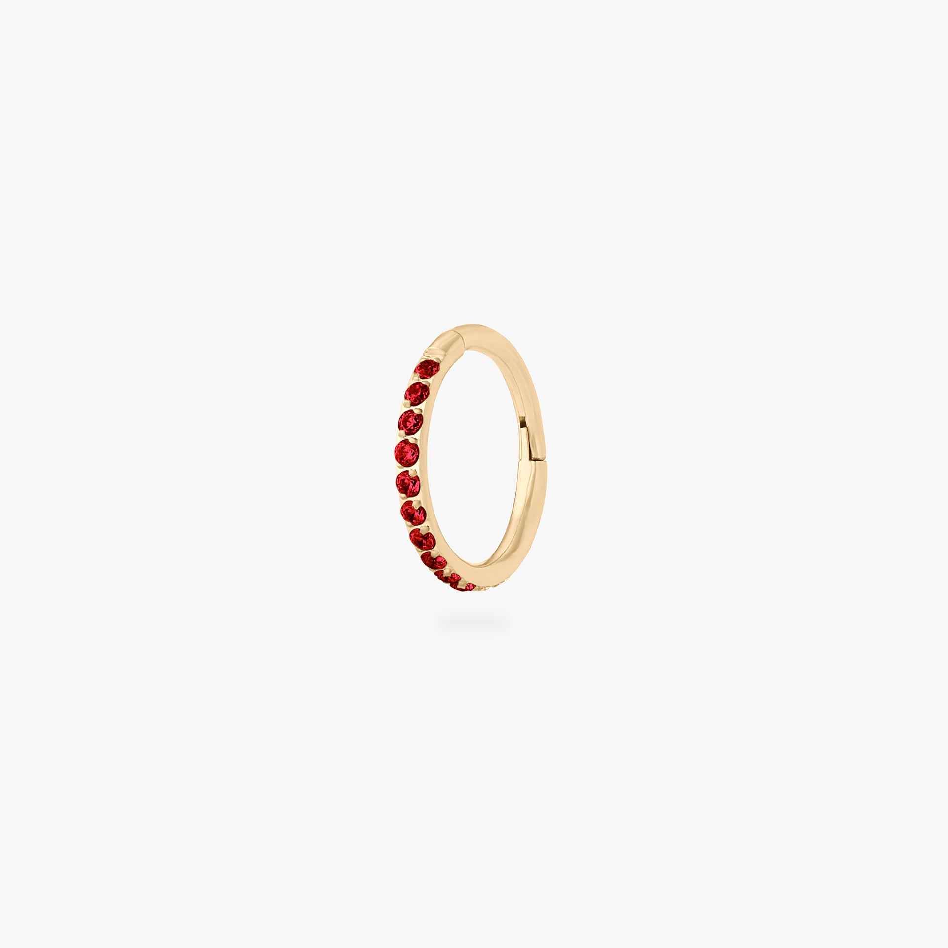 This is a gold toned clicker with garnet cz stones. color:null|garnet