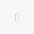 This is an image of a gold-toned titanium clicker with pearl cz stones. color:null|pearl