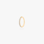 This is an image of a gold-toned titanium clicker with pearl cz stones. color:null|pearl