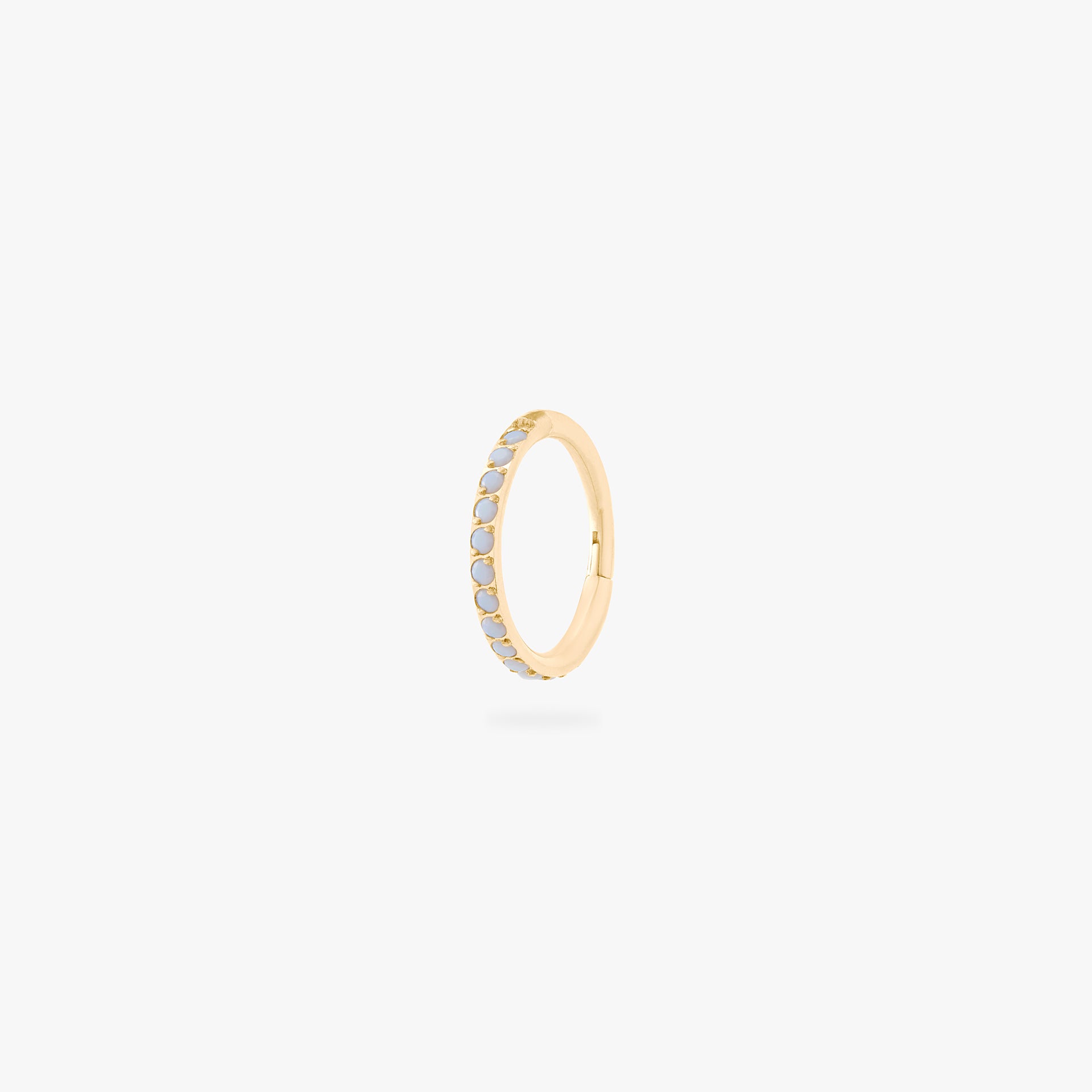 This is an image of a gold-toned titanium clicker with pearl cz stones. - Main view