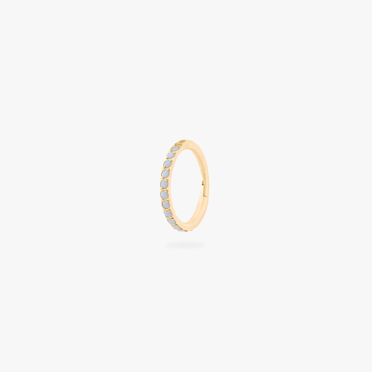 This is an image of a gold-toned titanium clicker with pearl cz stones. color:null|pearl